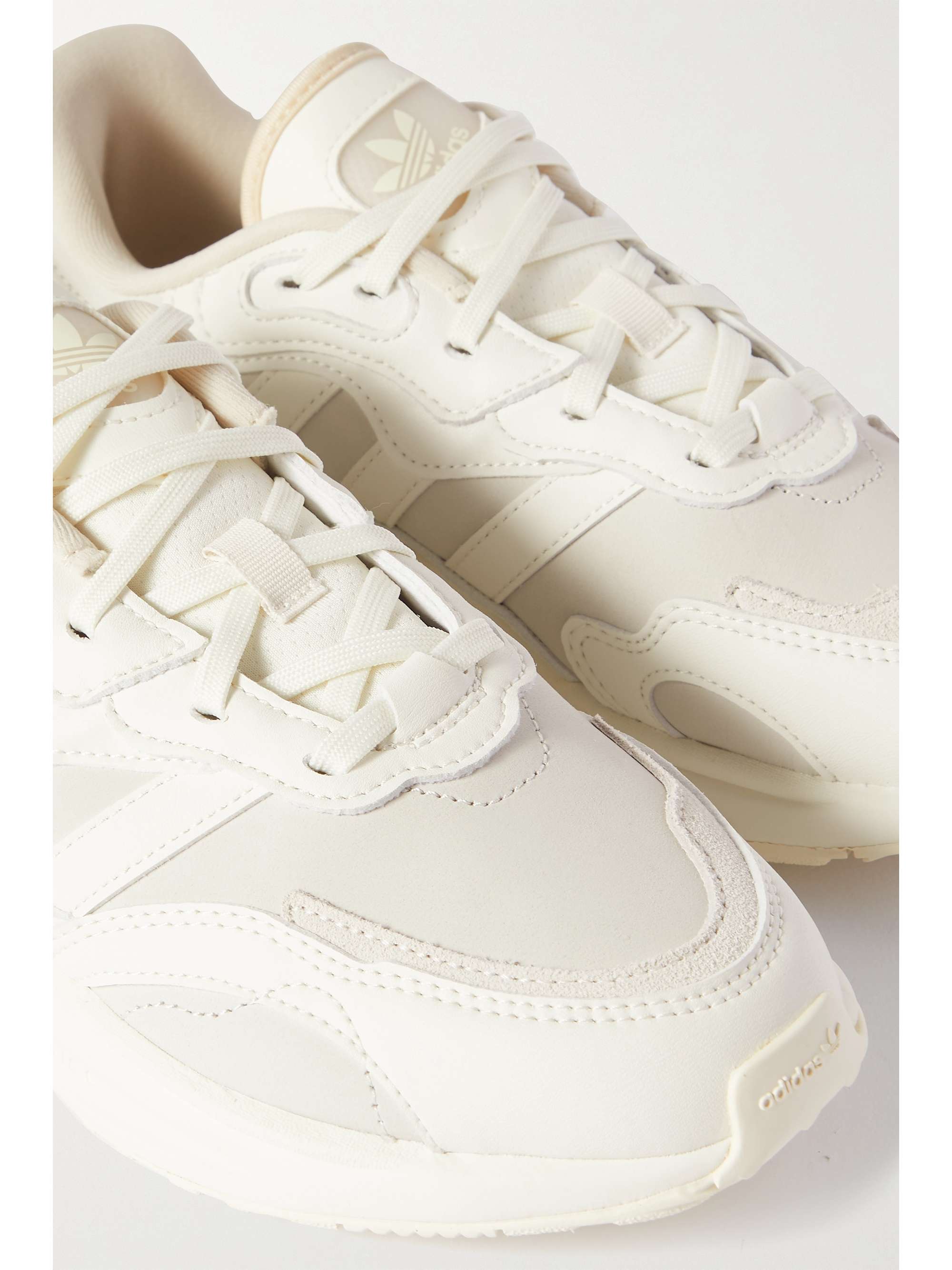 white netted adidas trainers