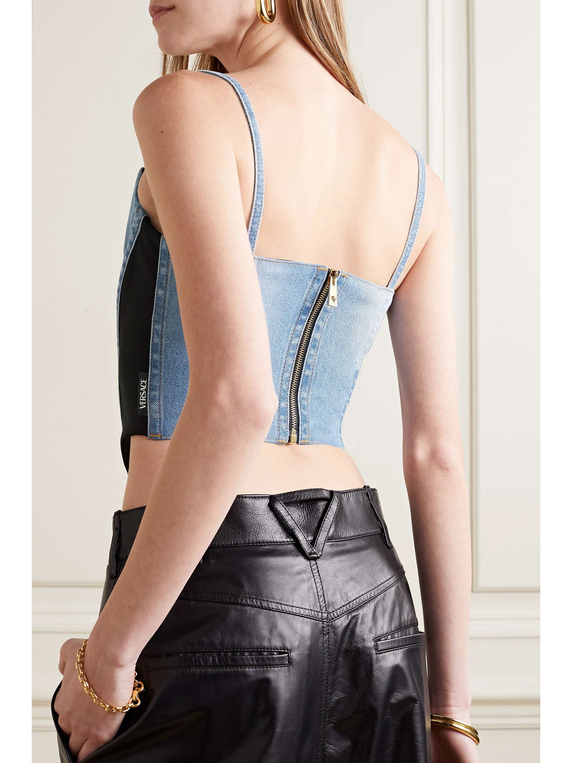 VERSACE Cropped embellished paneled denim and jersey bustier top