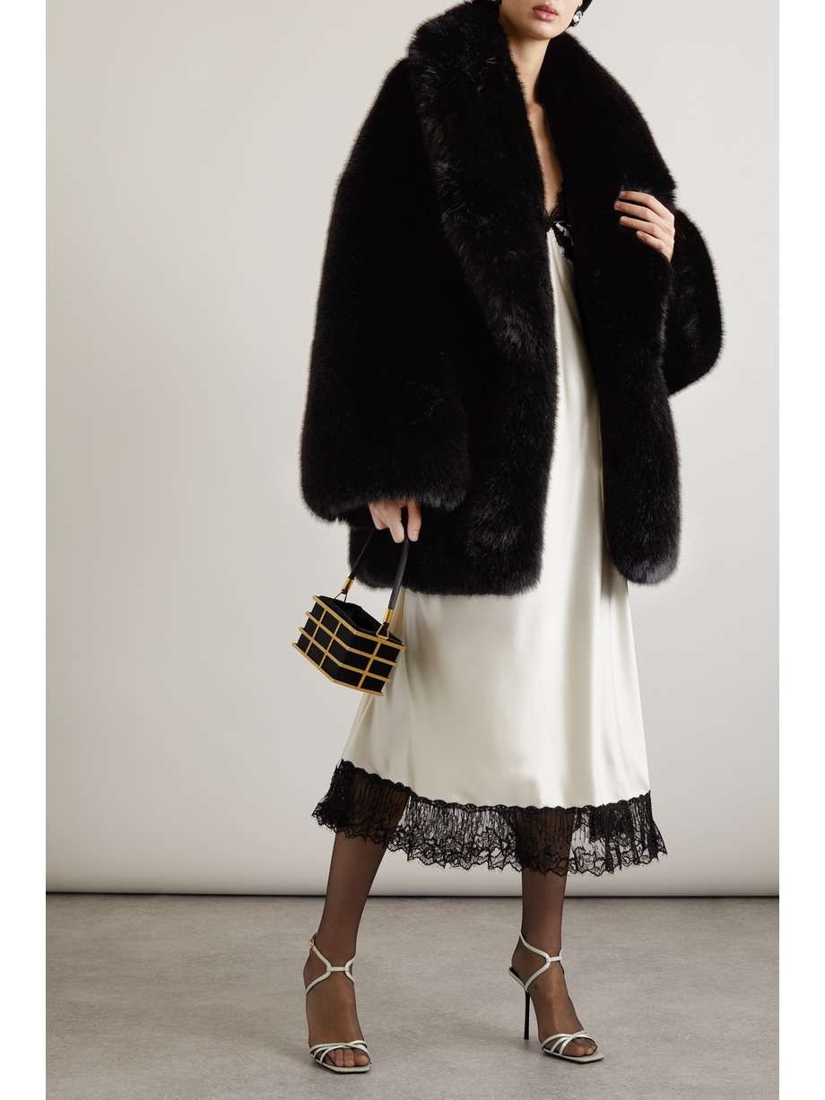 SAINT LAURENT's coat is crafted from black faux fur that looks and feels so glamourous. Designed for a relaxed fit, it has a dramatic shawl collar and oversized sleeves.