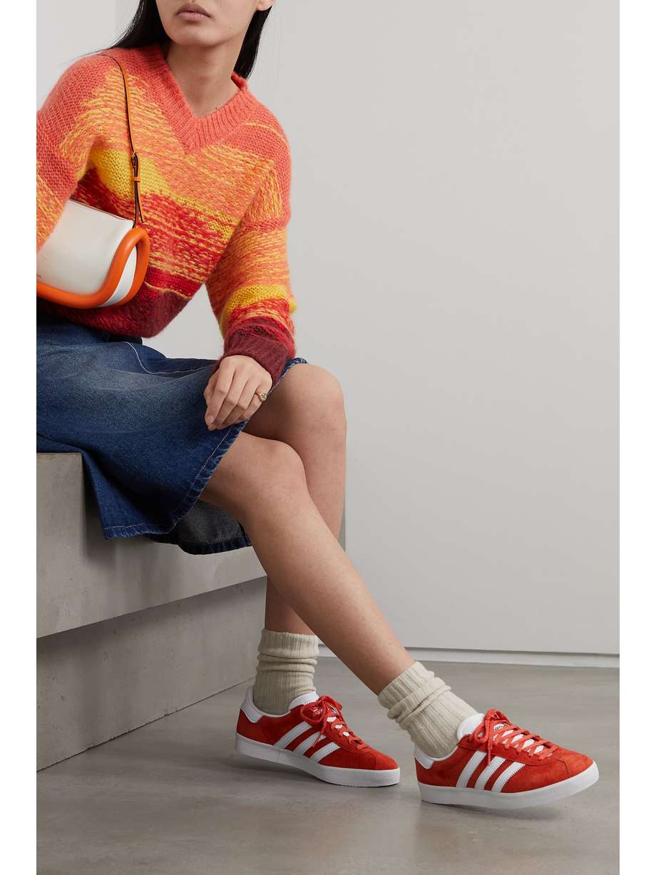 adidas Originals' Red 'Gazelle' sneakers are nothing short of iconic in the streetwear sphere - this pair recalls an archival style first released in 1985. Trimmed with leather, they're made from smooth suede 'Preloved Red' colorway and feature the signature three stripes at the side.