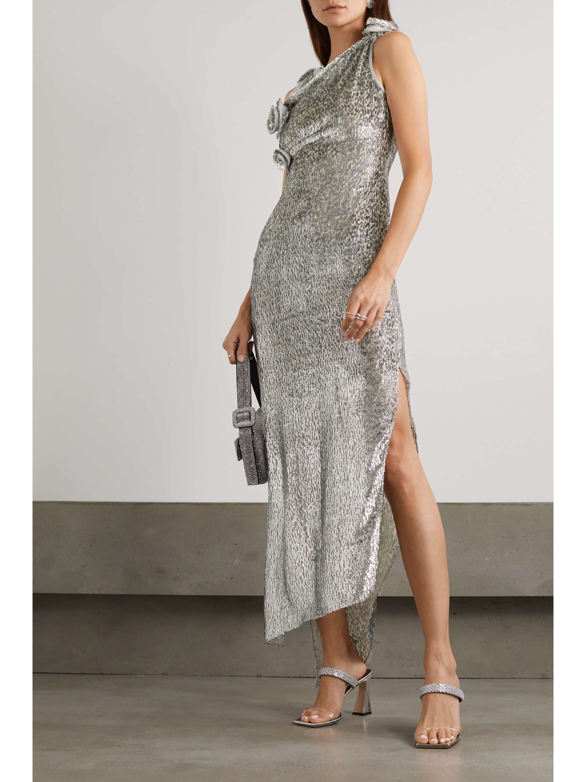 Made from lightweight voile, this Coperni asymmetric appliqued metallic fil coupe voile dress is flecked with glittering silver fil coupé threads and has 3D flowers framing the draped bodice. This figure hugging, slip on dress would make a fashion forward choice for a bridal party dress look. 