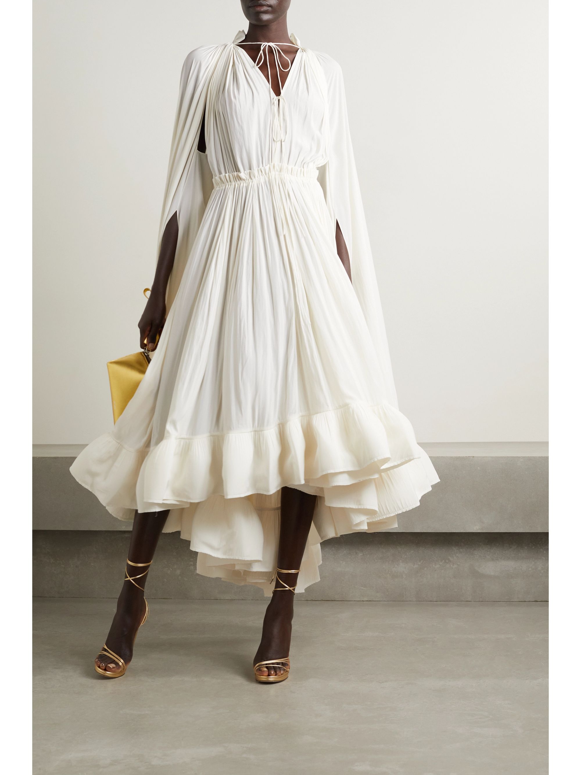 Lanvin's ethereal dress is cut from airy crepe and has long, cape-effect sleeves that cascade beautifully down the sides. It's detailed with adjustable ties along the plunging neckline and falls to a ruffled midi hem filled with organza to hold its voluminous shape. Style it with sandals or knee boots. It would make a dreamy bridal look. 
