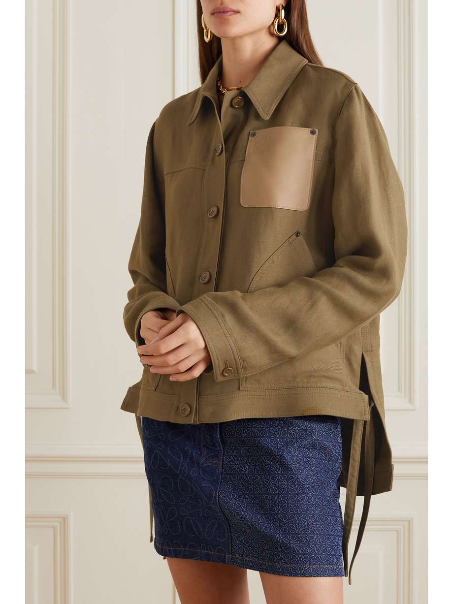 Loewe leather trimmed linen blend twill jacket in khaki is crafted from sturdy linen-blend twill. It's designed for a slightly loose fit and finished with a leather patch pocket that's embossed with the brand's signature 'Anagram' moniker. Leave the buttons undone and layer yours over a T-shirt.