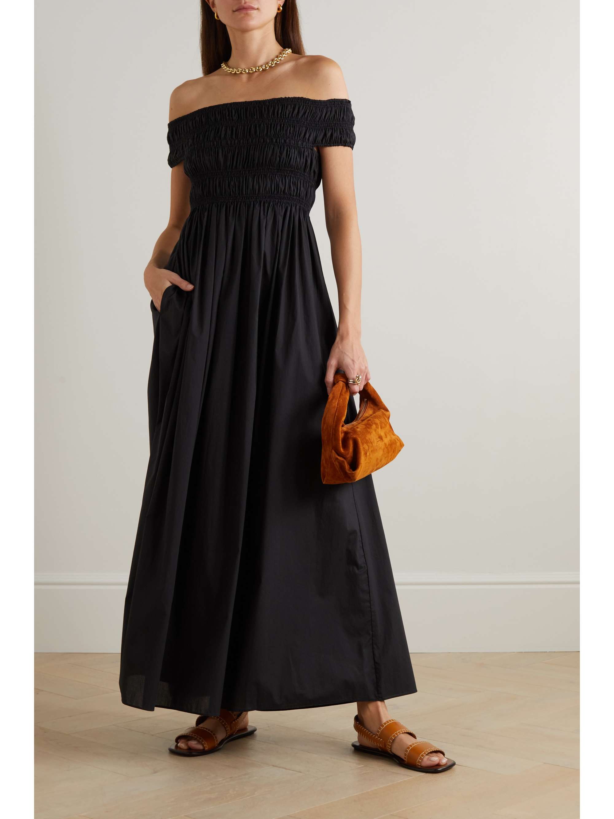 Black summer dresses are the versatile and easy way to get dressed on hot summer days! A lesson for wearing black in hot climates, Matteau's dress looks and feels effortlessly chic. It's made from crisp cotton-poplin that's shirred through the off-the-shoulder bodice and falls to a full maxi skirt. Just add gold-tone hoops and sandals.