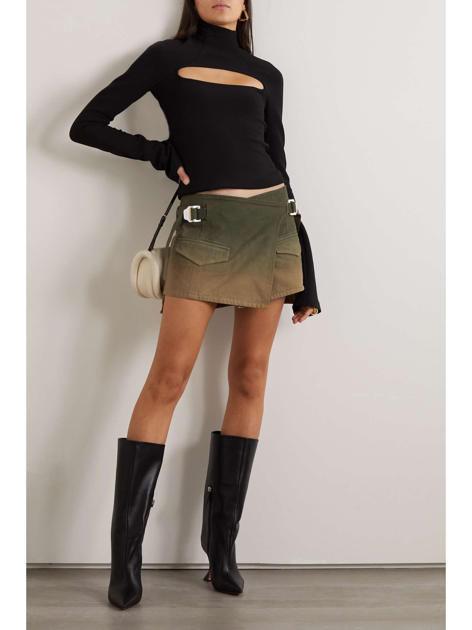 Inspired by utilitarian design, Dion Lee's wrap mini skirt features double buckles and cargo pockets. It's cut from denim that's been garment- and reverse-dyed for a gradient effect. Style yours with a cropped top to showcase the 'V'-shaped waistband.