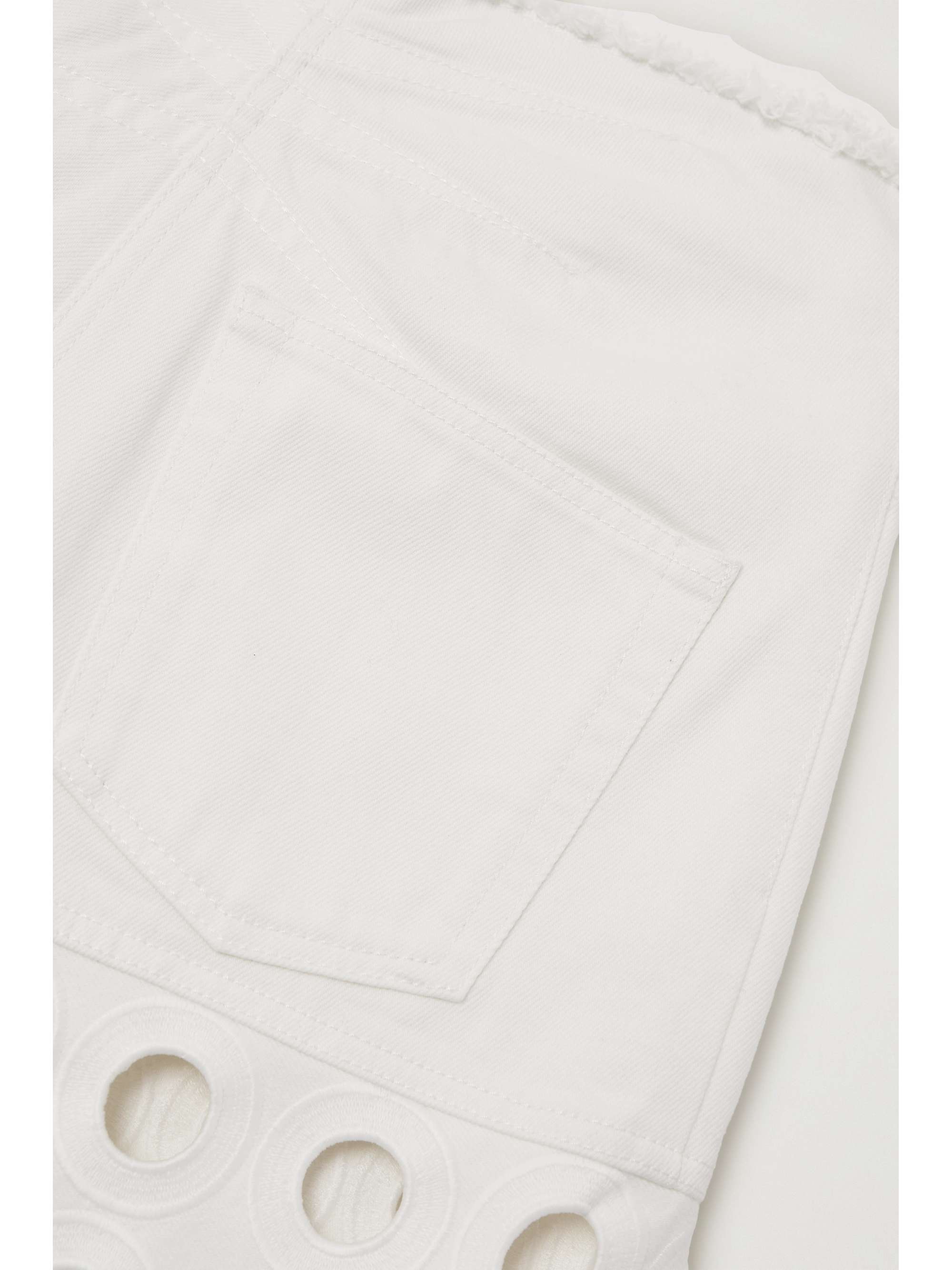 ALAÏA Embroidered laser-cut frayed low-rise jeans