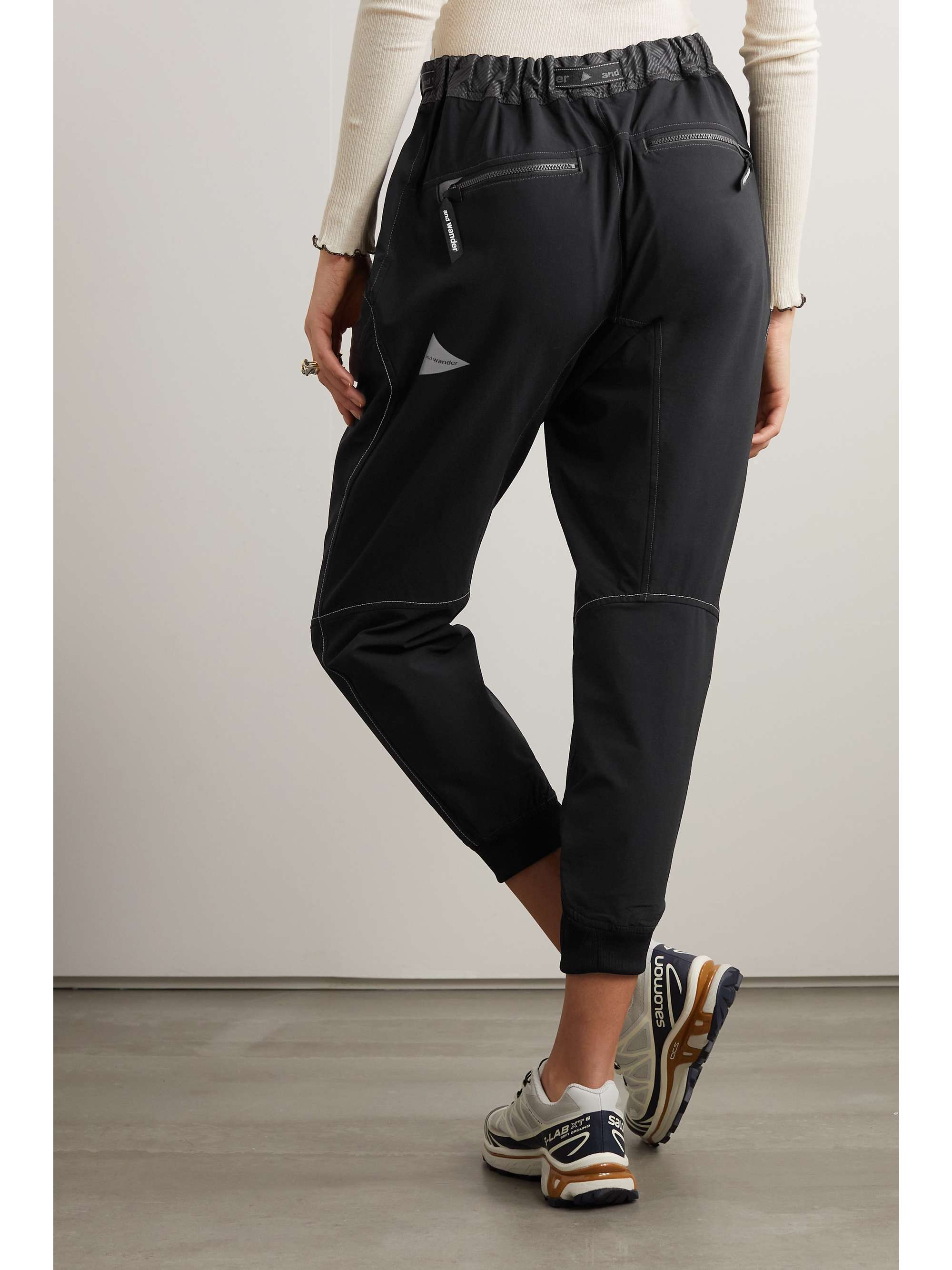 AND WANDER Saruel cropped belted tech-jersey pants
