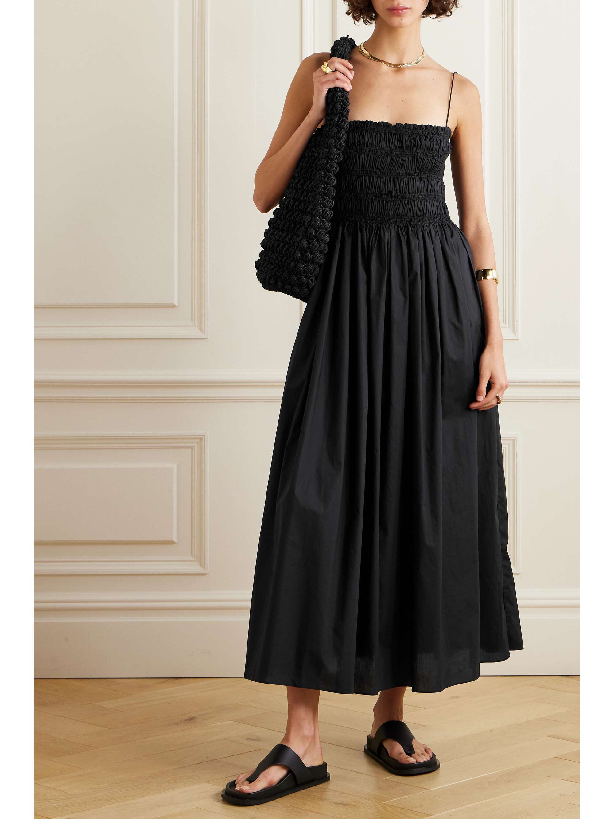 Matteau's black midi dress ensures you always have something effortless and stylish to wear for casual plans. It's been locally made in Australia from certified organic cotton that's shirred through the bodice for a close yet flexible fit and has a floaty skirt that moves beautifully as you walk. You can easily tuck in the slim straps to create a strapless neckline.