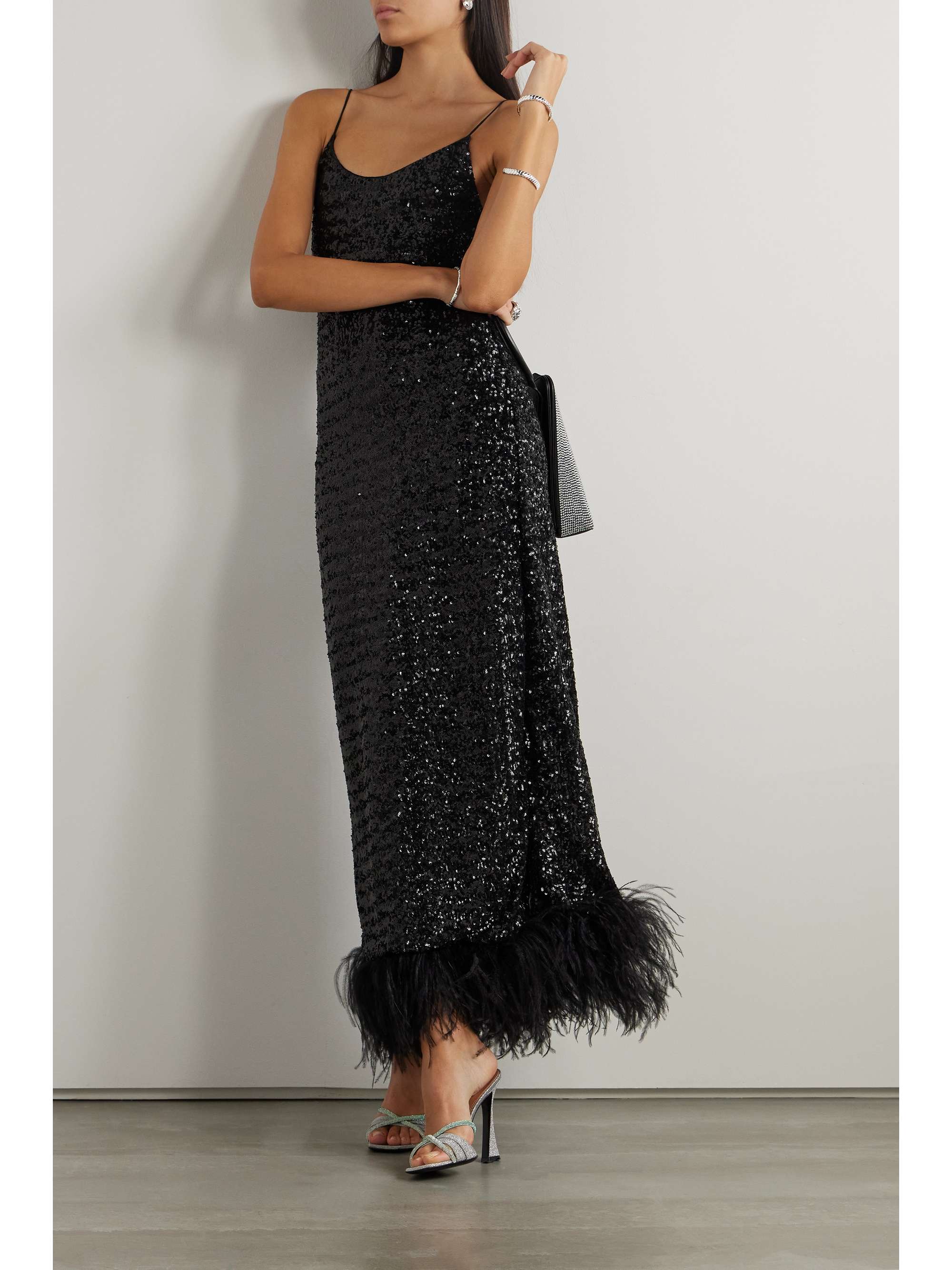 Oséree's maxi dress is sure to steal the spotlight at any event. It's made from black satin stitched with hundreds of light-catching sequins and trimmed with wispy feathers that shimmy as you move. When it comes to accessories, more is definitely more.
