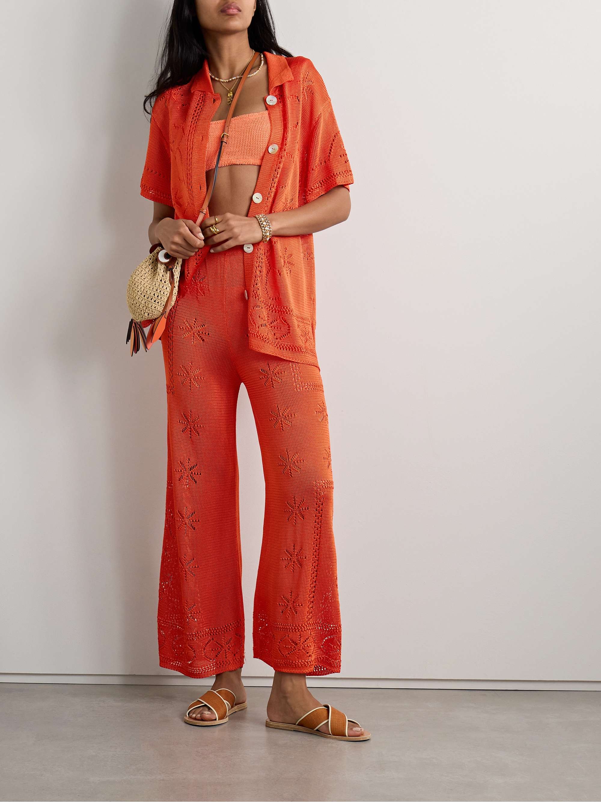 Calle Del Mar's shirt is pointelle knitted with a beachy floral motif that's inspired by tablecloths owned by founder Aza Ziegler's family. Modeled after traditional menswear, it has a neat pointed collar and lustrous buttons. The relaxed fit ensures easy layering over swimwear or tanks.