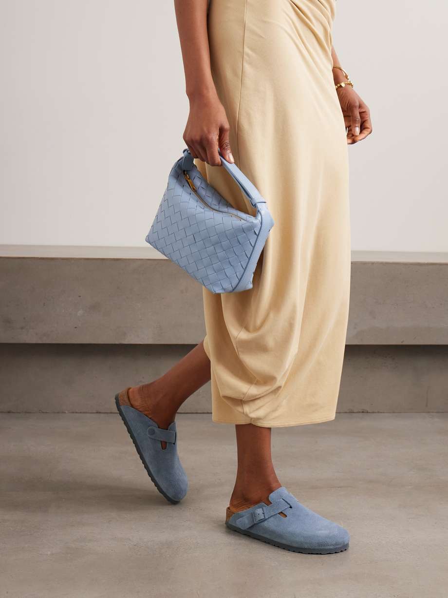Debuted in 1977, Birkenstock's iconic 'Boston' clogs are still so highly regarded for their comfort and ease. This pair has been made in Germany from suede and set on ergonomic cork soles designed to mold to your feet over time. They also have the brand's signature buckled strap at the side.
