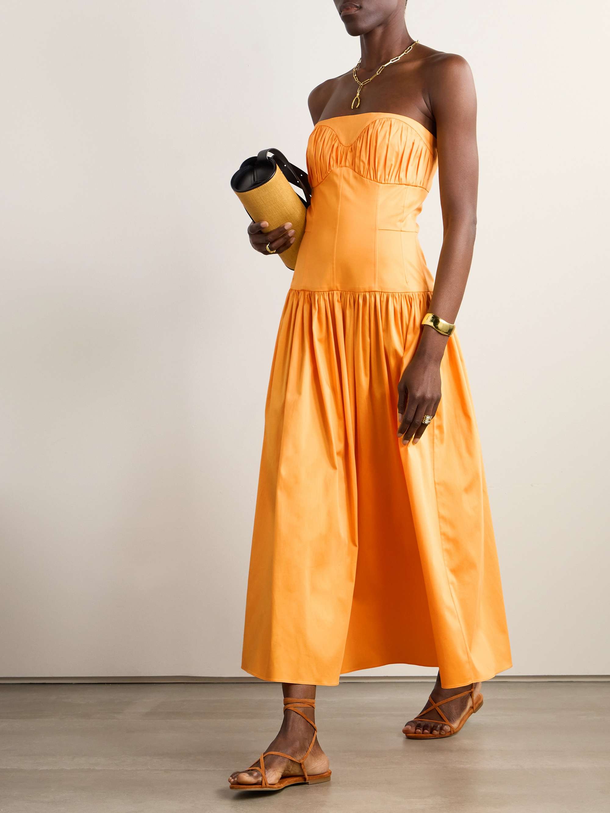 EXCLUSIVE AT NET-A-PORTER. The sunset orange of TOVE's 'Lauryn' dress will glow beautifully in your vacation snaps. It's made from organic cotton-poplin - the fine, crisp textile is paneled to fit closely through the strapless bodice, while the gathered skirt moves breezily.