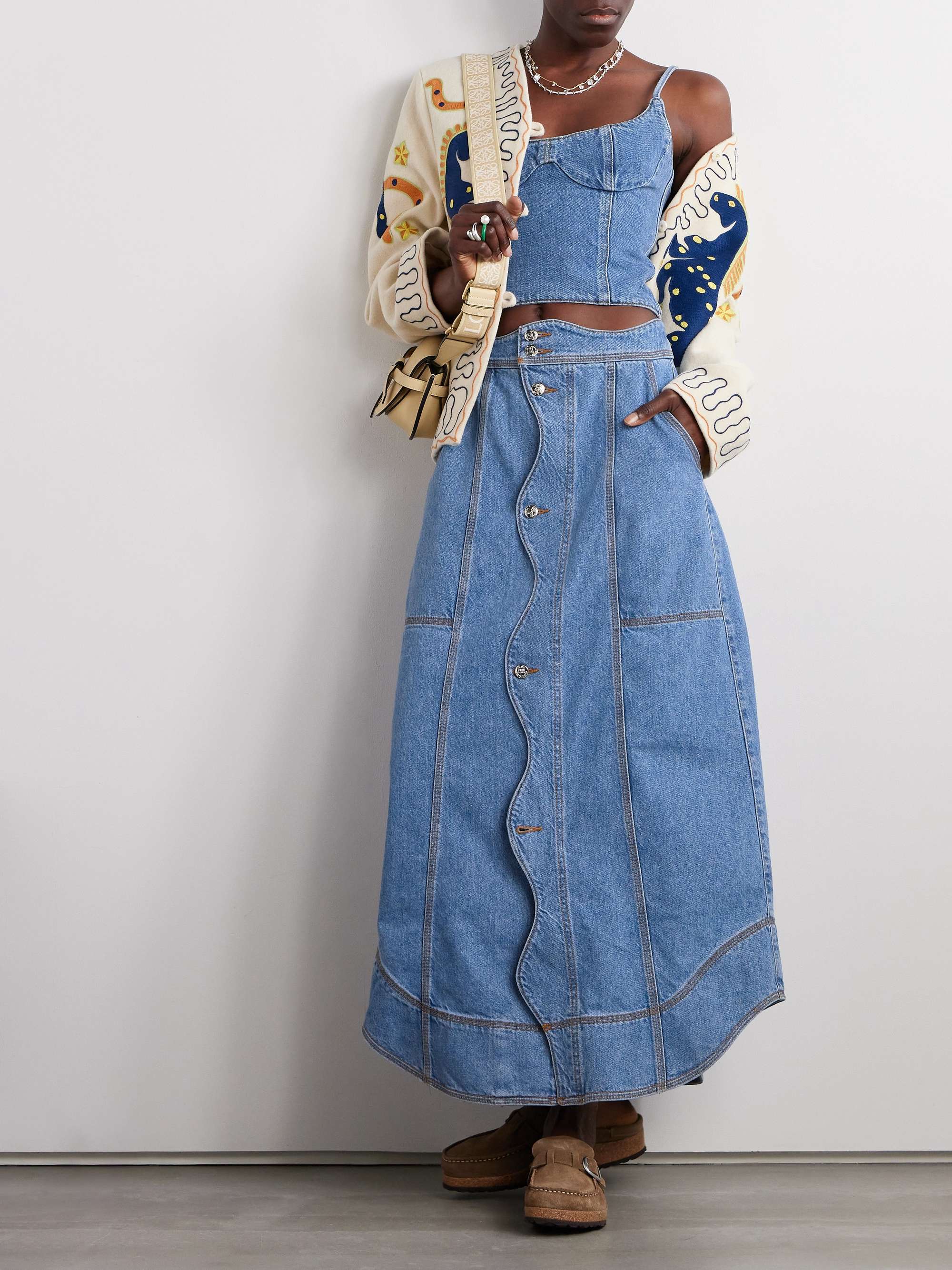 Farm Rio's midi skirt is traced with waved edges that resemble the soothing movements of the sea. It's constructed from panels of denim and falls to a contemporary asymmetric hem. Wear yours with the matching top and a printed jacket.