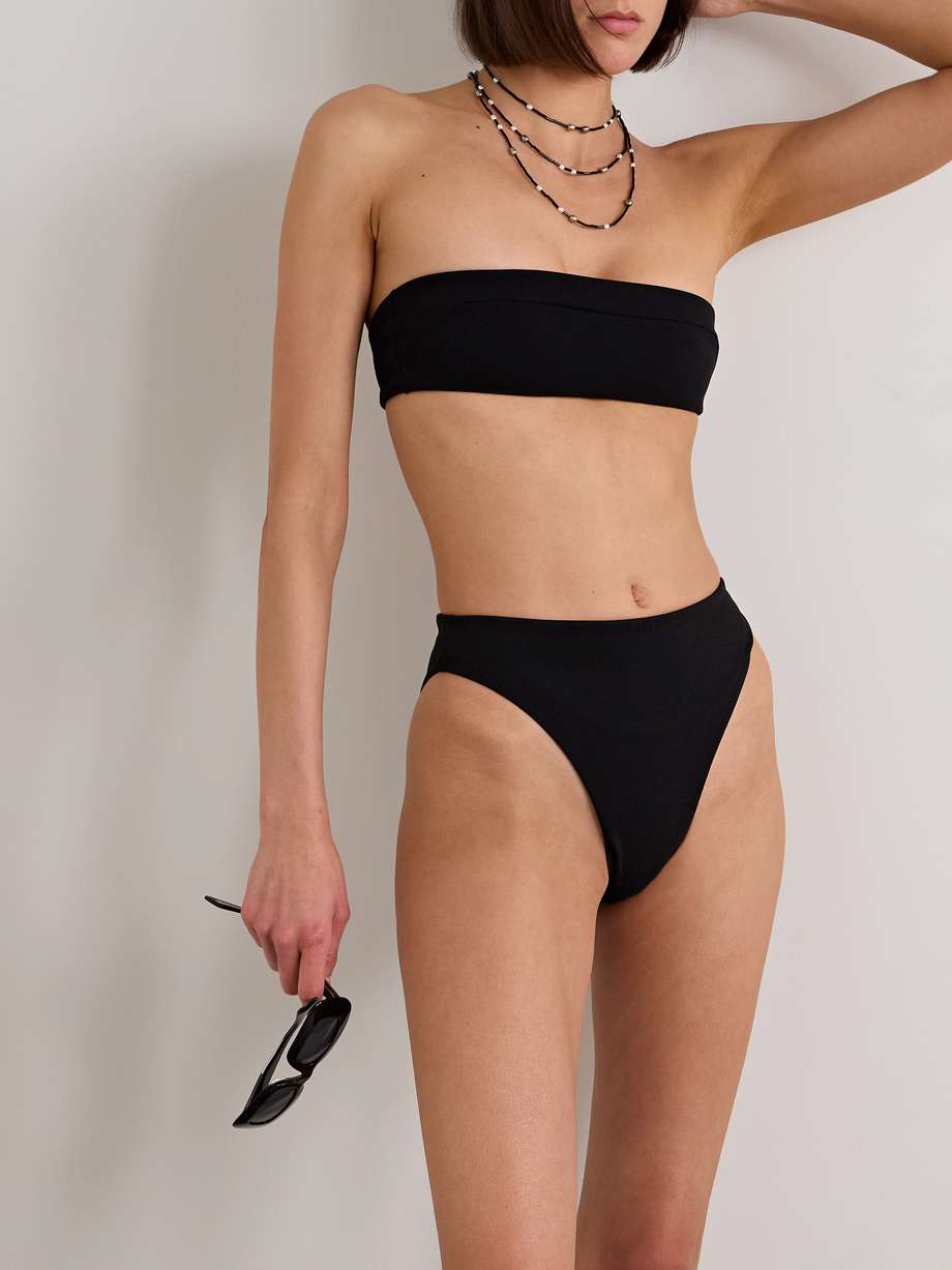 2024 swimwear trends - Designed with clean, simple lines, Haight's swimwear has a timeless appeal. Featuring the 'Gabi' bandeau top and high-cut 'Mah' briefs, this bikini is made from quick-drying crepe with a touch of stretch. Wear yours to the pool with a pareo.