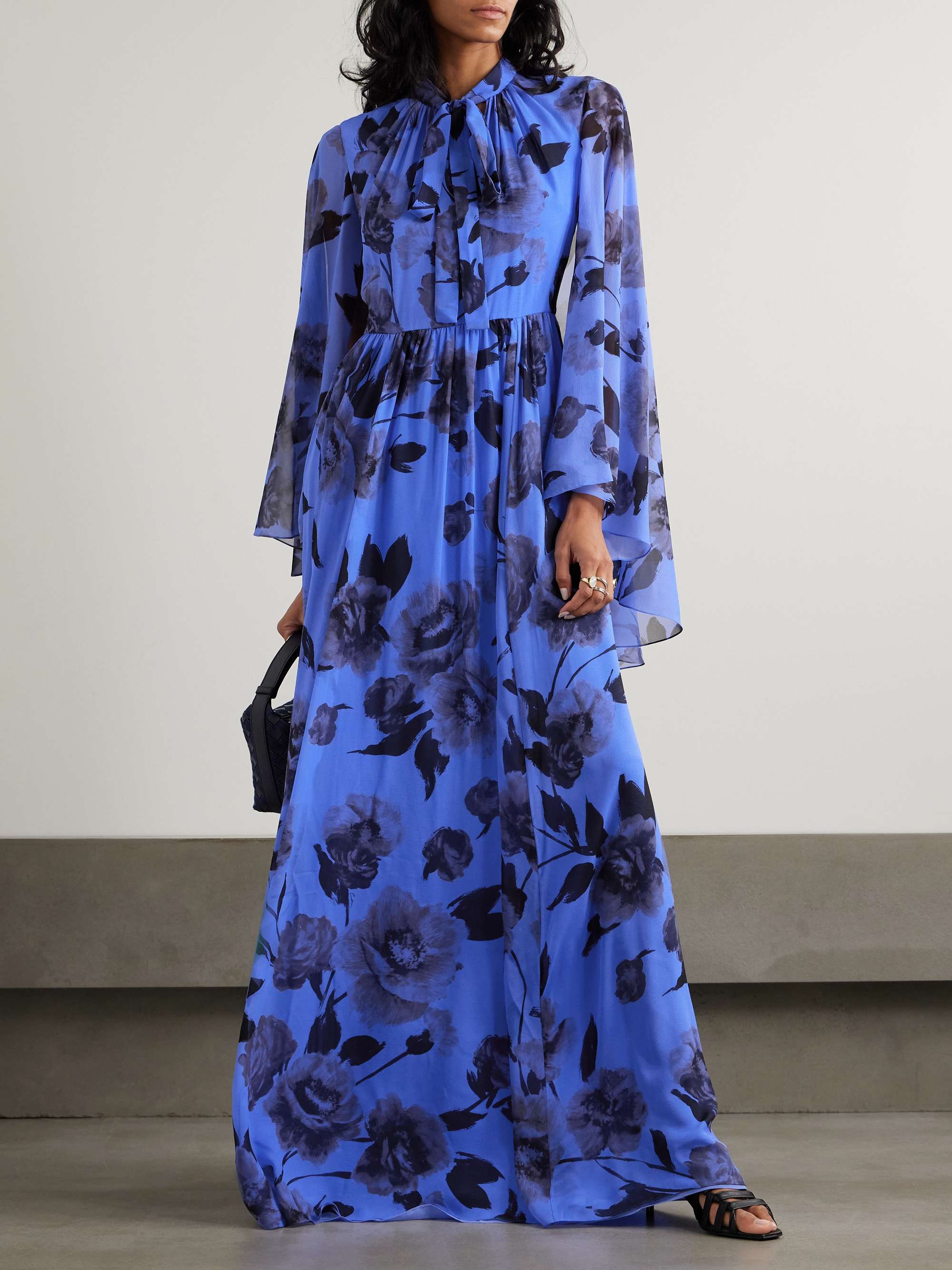 Erdem's gown draws on the svelte silhouettes of '30s styles, which always feel elegant. It's made from weightless silk-voile that's patterned with pretty flowers and gathered at the high neck and waist. The cascading sleeves enhance its fluidity and the ties can be fastened neatly or left to drape.