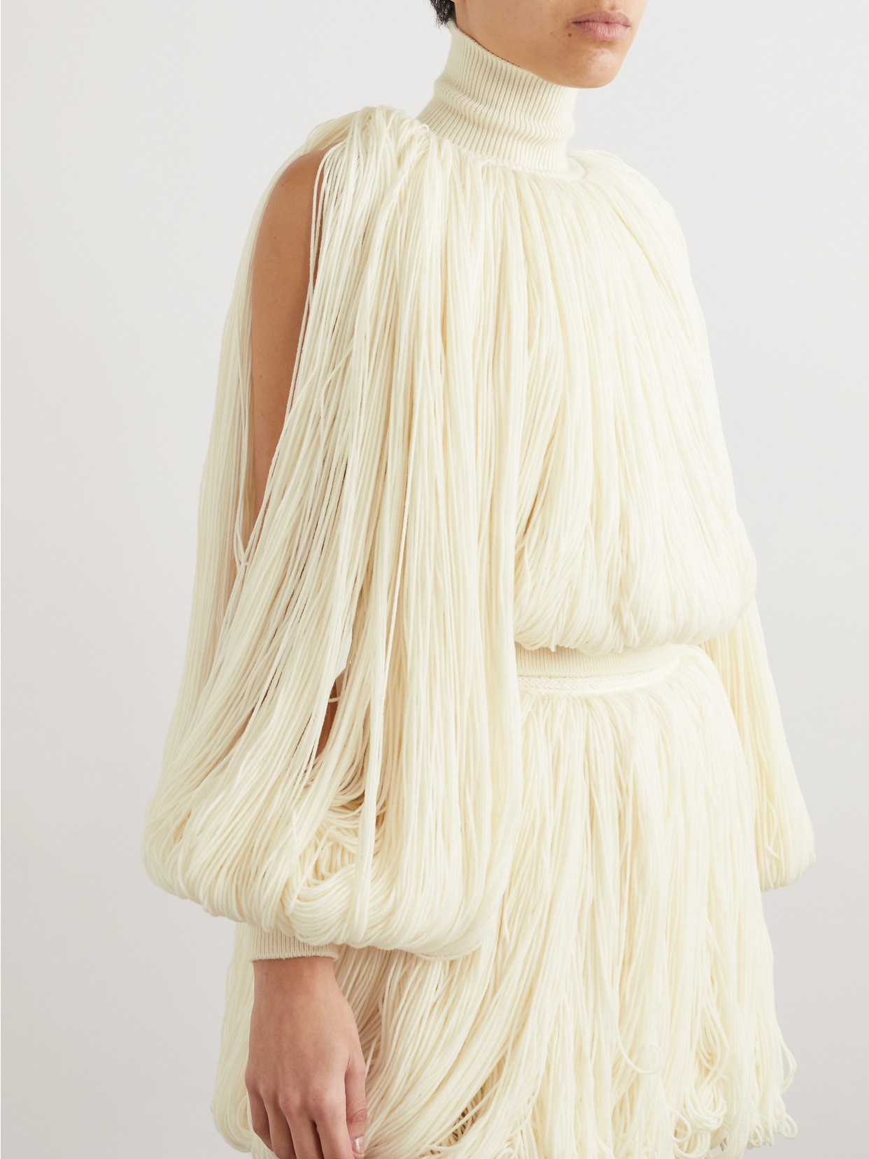 ALAÏA FRINGED WOOL-BLEND TURTLENECK TOP