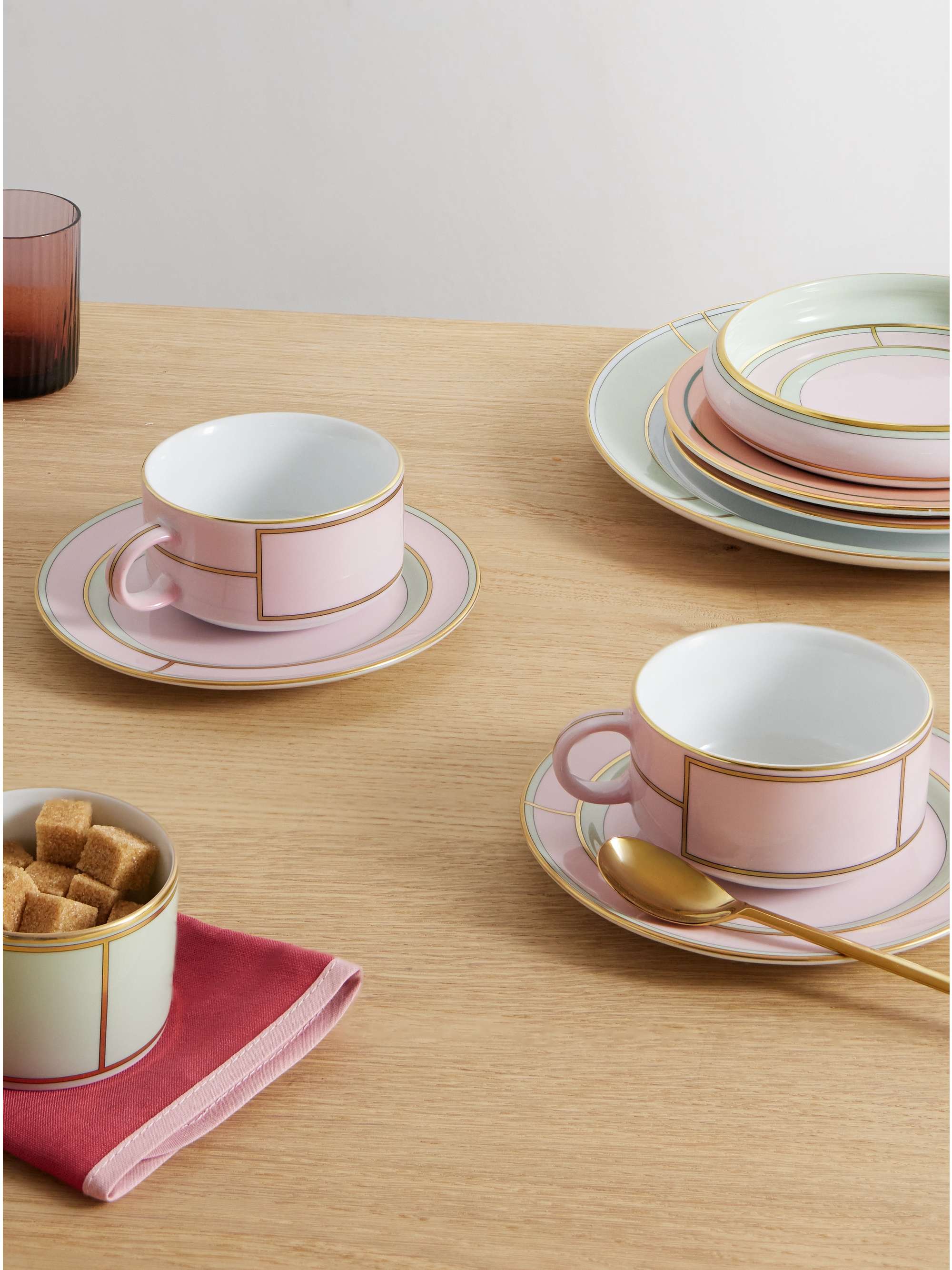 Set of two gold plated porcelain tea cups and plates