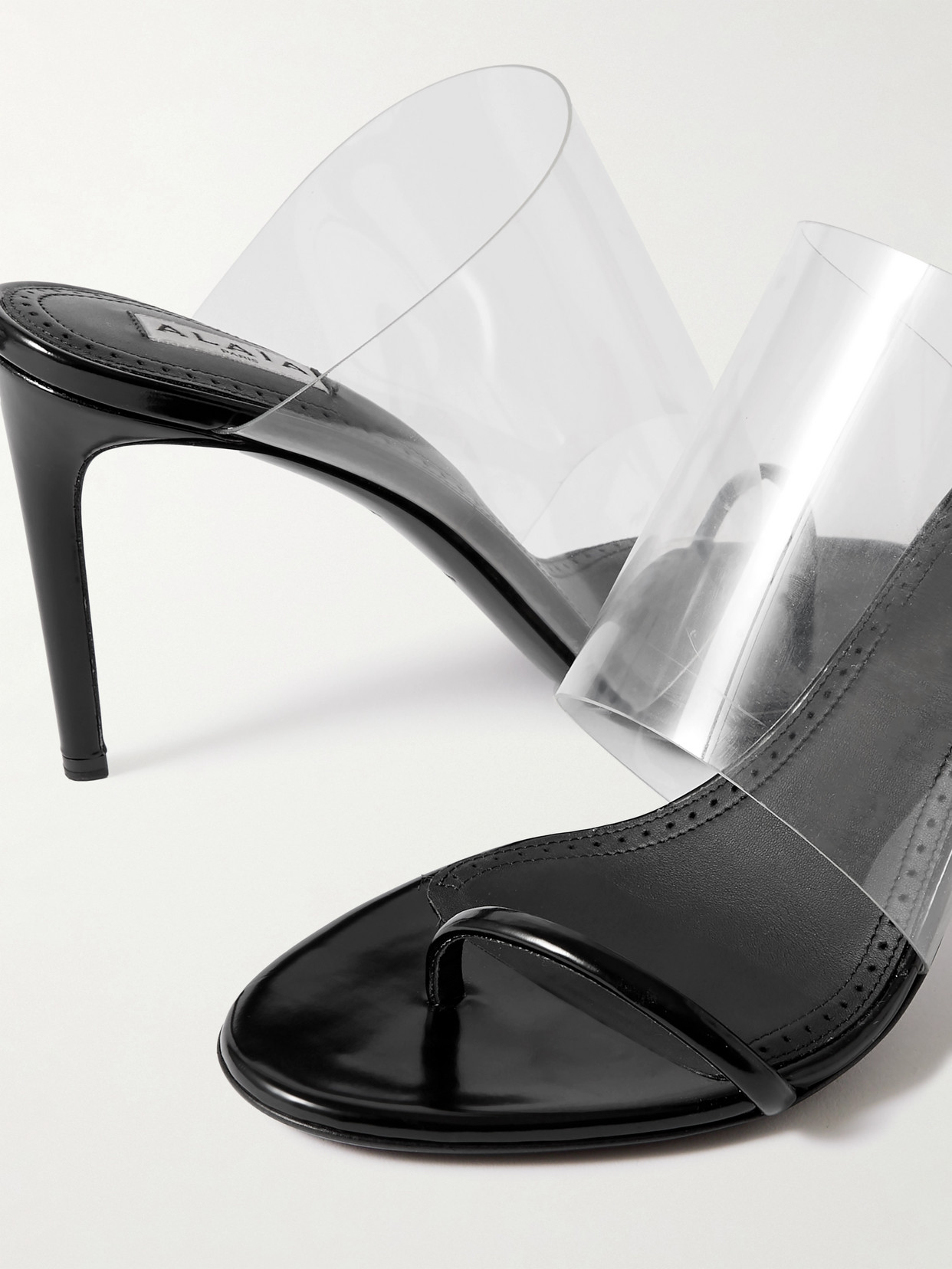 Shop Alaïa Asymmetric Patent-leather And Pvc Sandals In Black