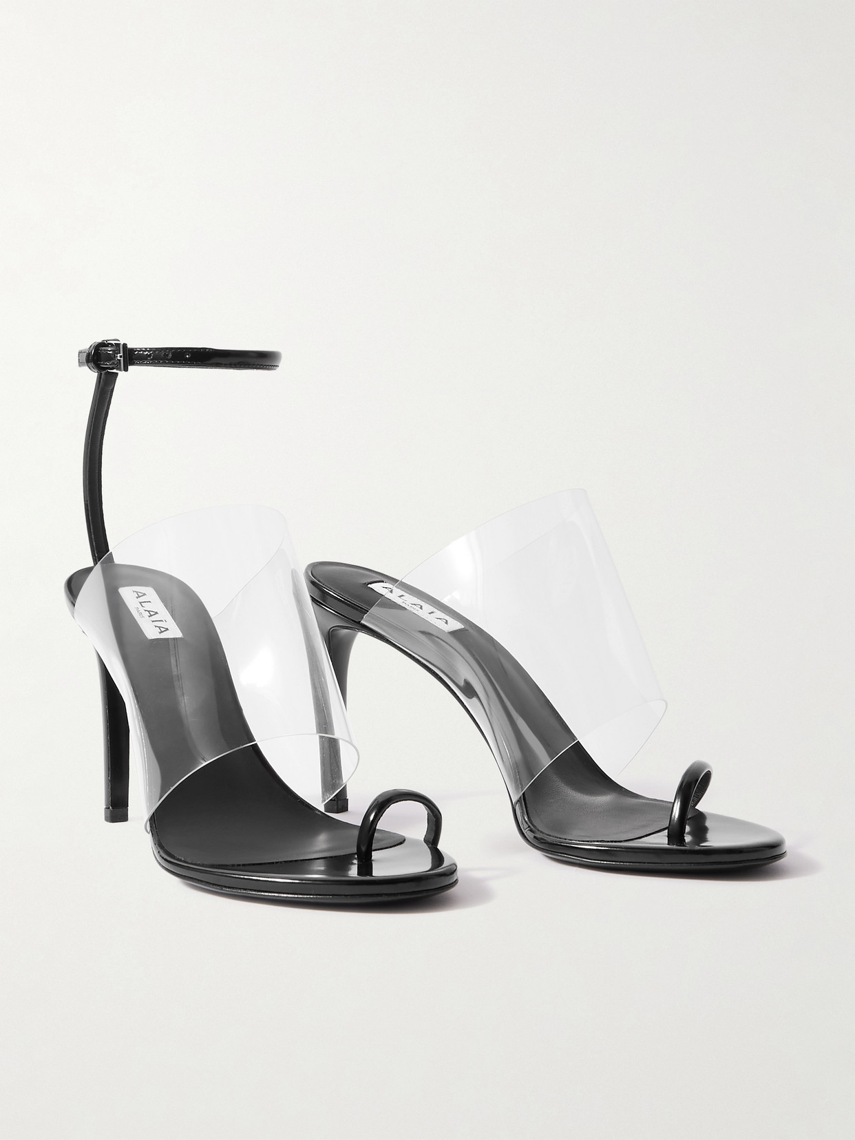 Shop Alaïa Asymmetric Patent-leather And Pvc Sandals In Black