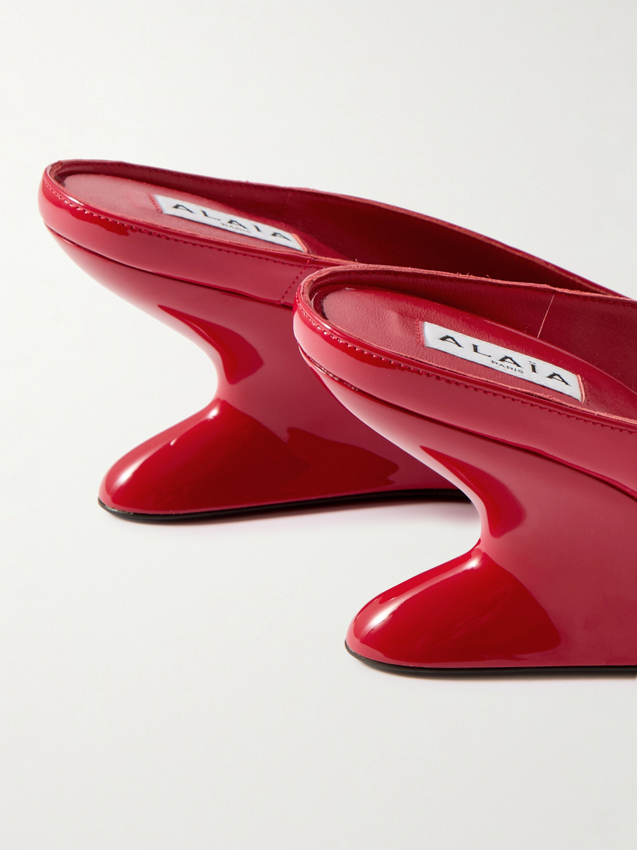 Shop Alaïa Patent-leather Wedge Mules In Red
