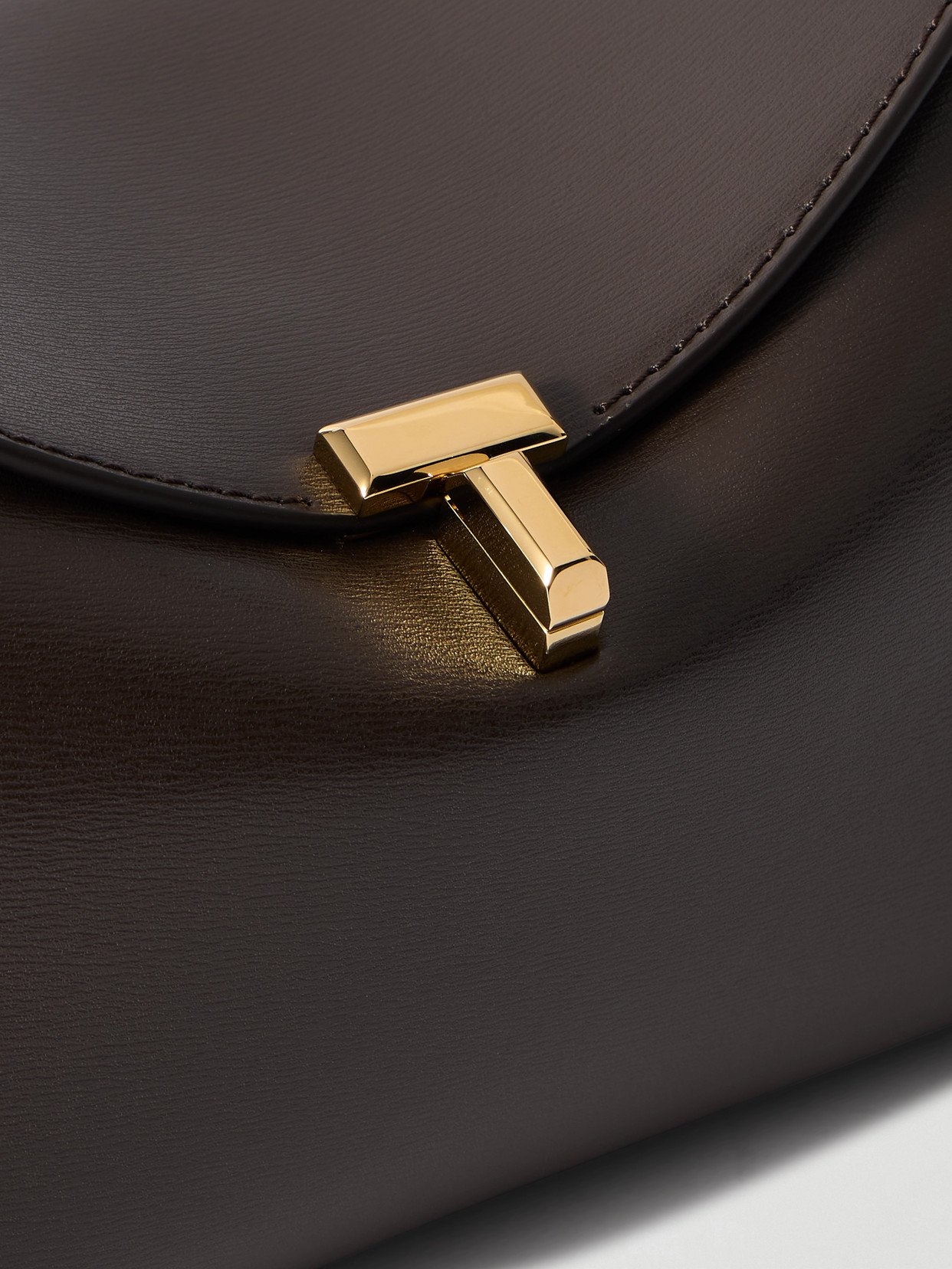 Totême T-lock Textured-leather Clutch In Brown