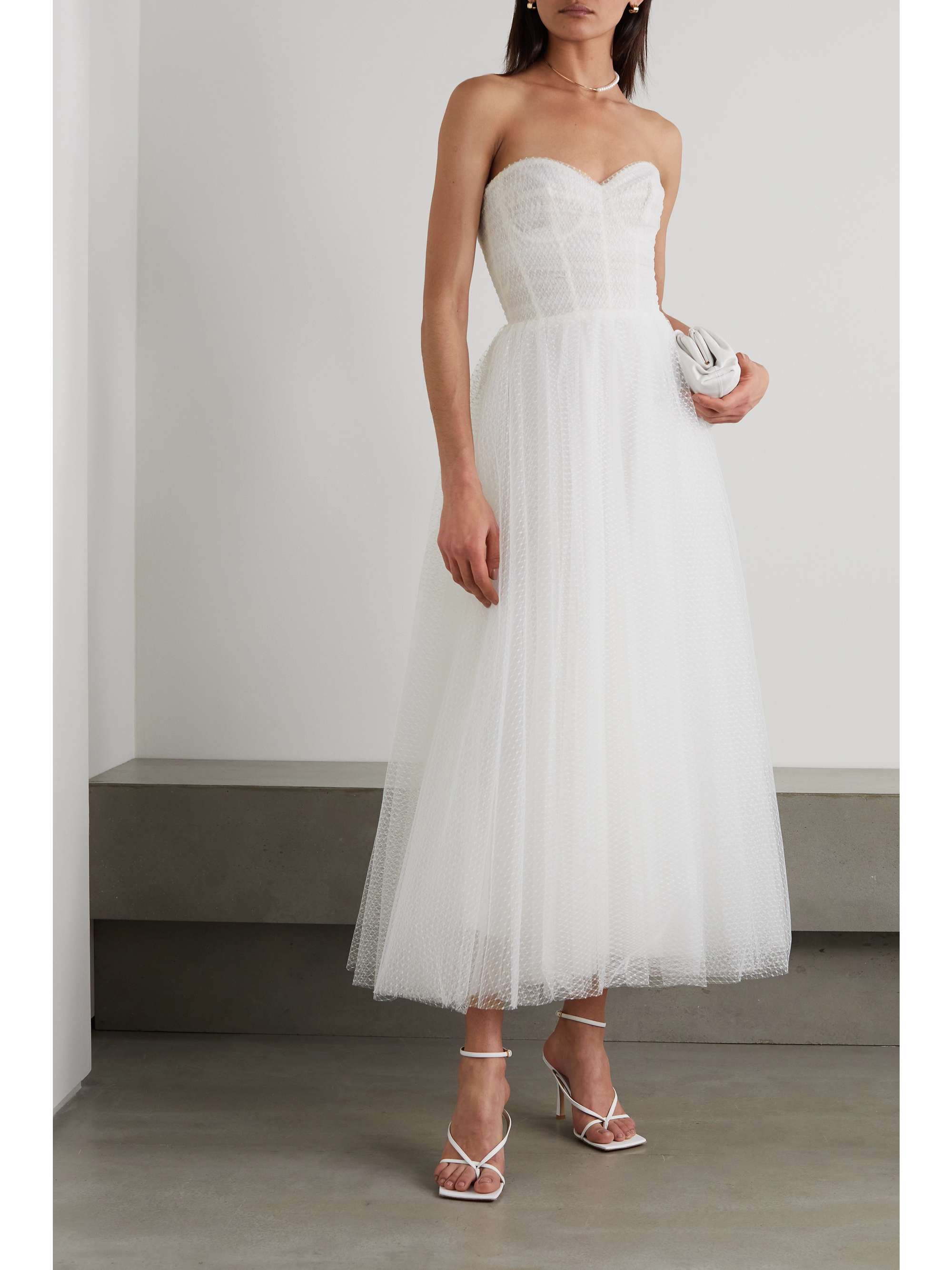 Monique Lhuillier 'Brie' tea gown is cut from white Swiss-dot tulle and has a strapless bodice that's boned to ensure it won't slip down during photographs or your first dance. It has a sweetheart neckline and a nipped waist with a full skirt that reaches to the ankles. 