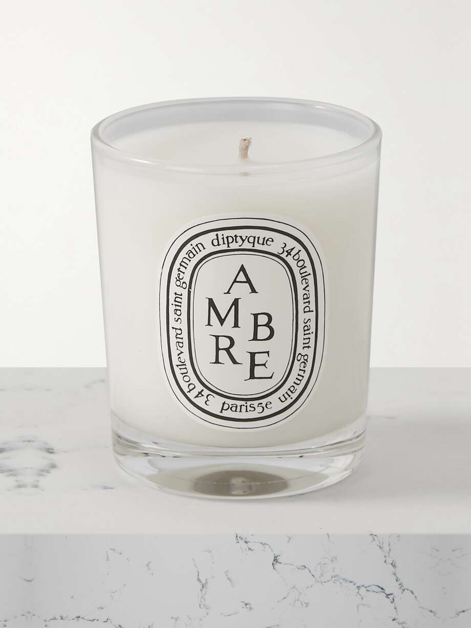 Chic Secret Santa Gift Ideas for every budget in 2023. Diptyque's 'Ambre' candle is a warm, woodsy blend of Vetiver and Patchouli enhanced with Spice, Incense and Tonka Bean. The minimalist packaging and glass vessel are aesthetically pleasing. Relax and let this elegant scent fill your favorite room.