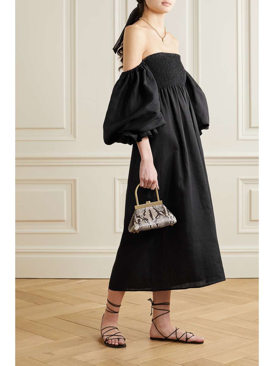 Black linen midi dress with off-the-shoulder balloon sleeves. Shirred at the bodice with a breezy midi length skirt. 