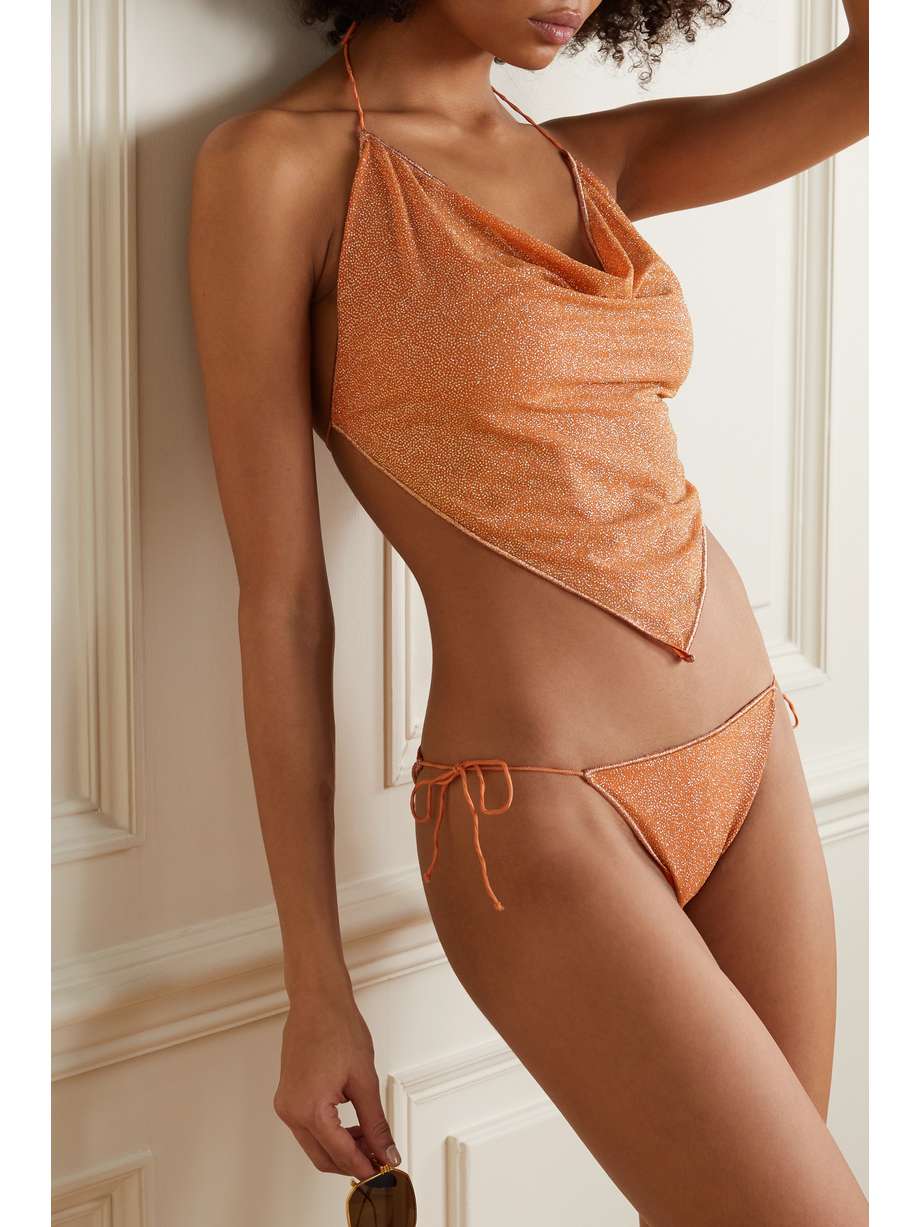 Oséree's 'Shine' bikini has a draped bandana top that resembles styles from the '00s. Made in Italy from glittered orange stretch-polyamide, it secures with slinky ties at the back and sides and offers medium brief coverage.