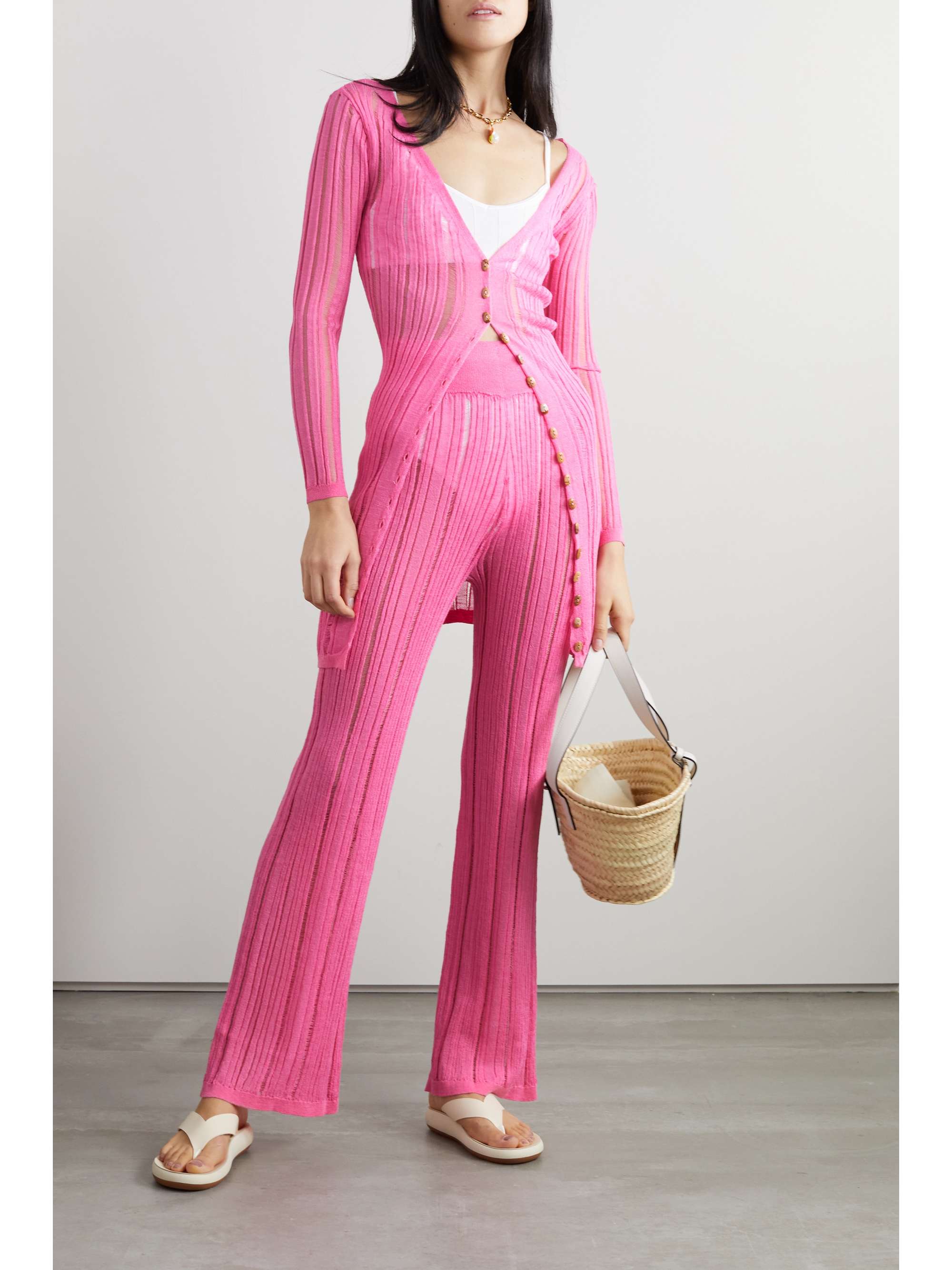 Pink Cult Gaia 'Laila' cardigan is Rib-knitted using an open stitch and has a delicately sheer finish that's great for layering in a lovely shade of pink and can be worn with matching trousers. 