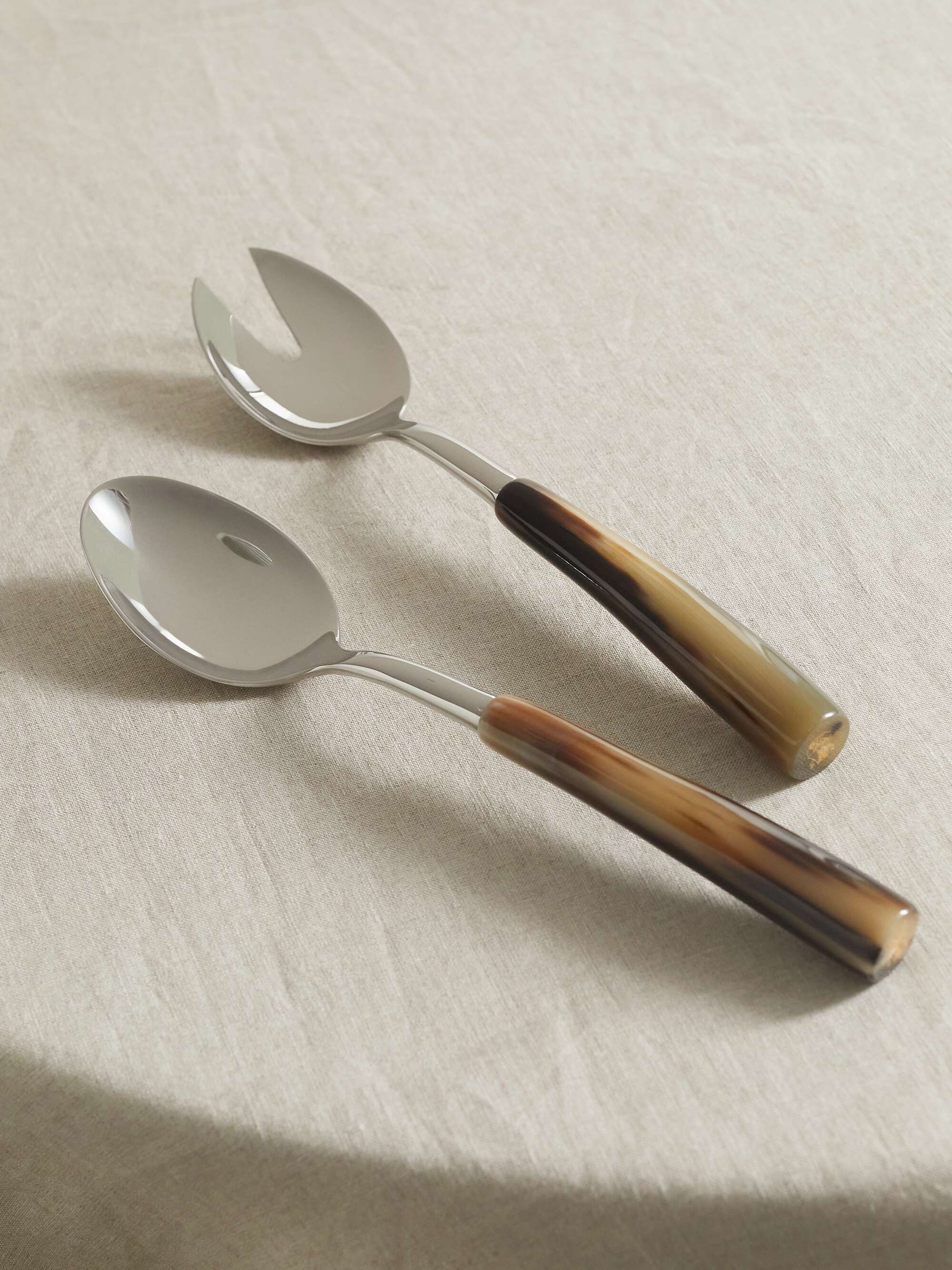 Set of two silver and horn serving spoons