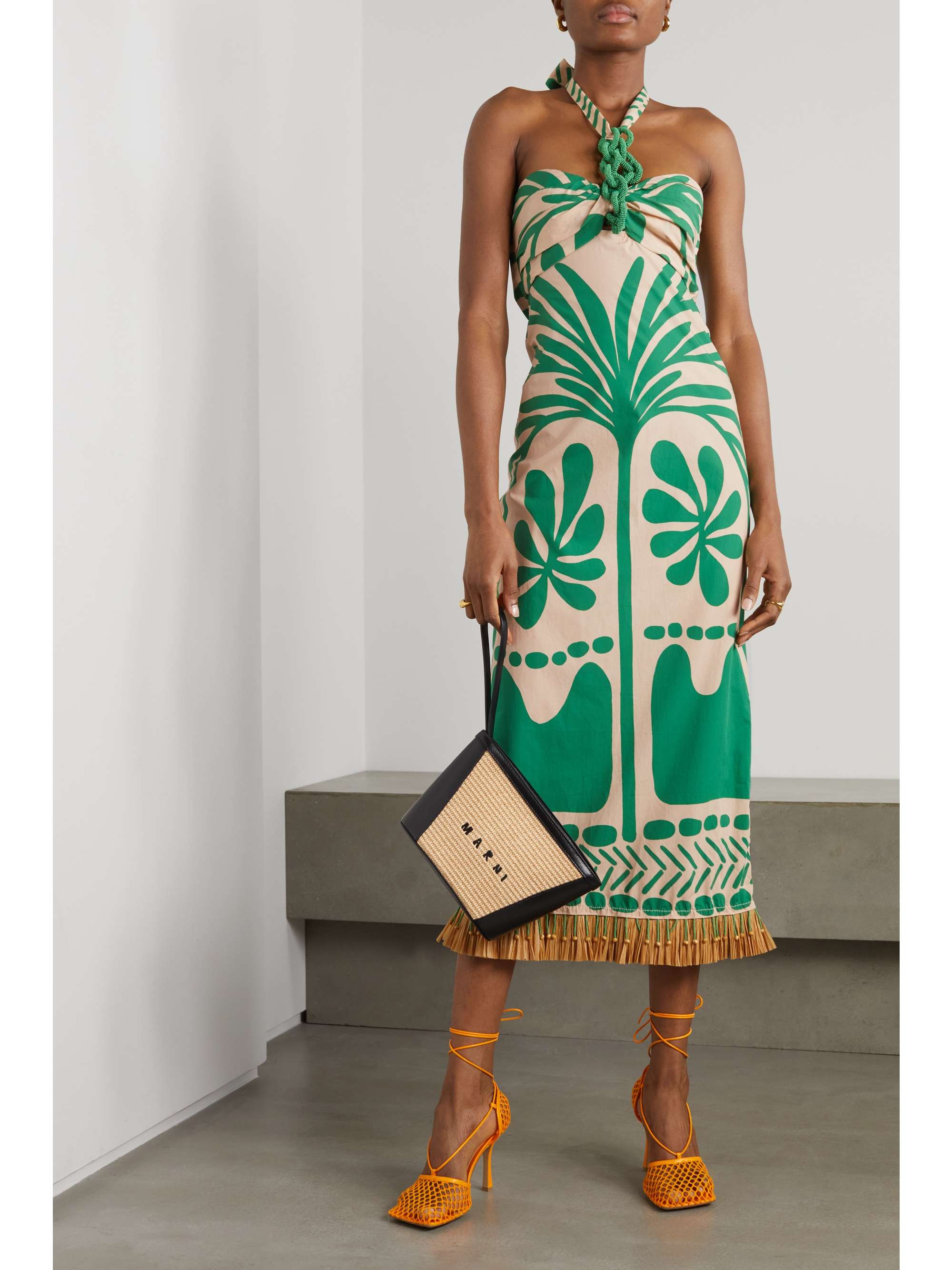 Johanna Ortiz's halterneck dress from the Spring '22 collection has been locally made in Colombia from breathable organic cotton printed with a foliage-inspired print. It's embellished with tonal beads and has a frayed hem.