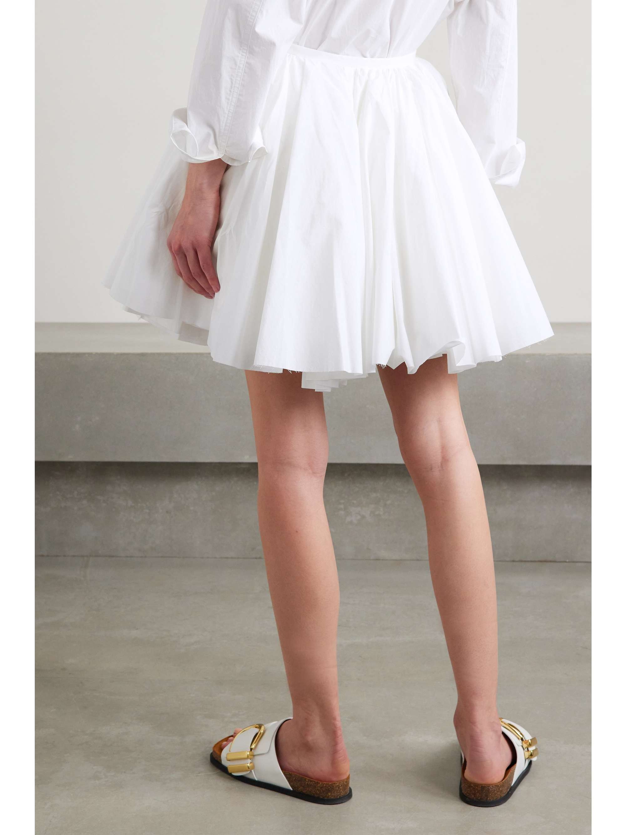 KHAITE Jorja layered pleated cotton-poplin mini wrap skirt