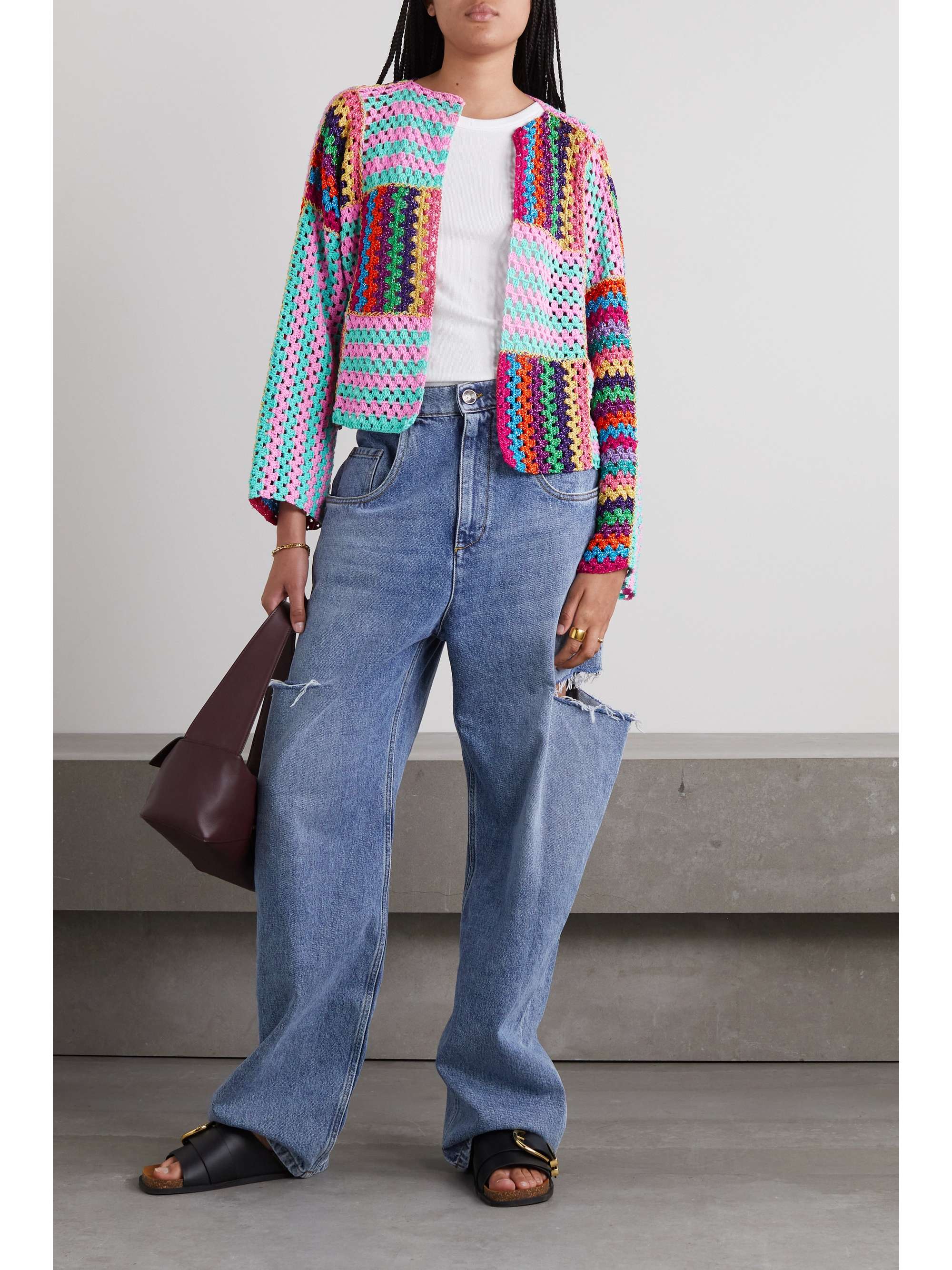 Rose Carmine multi coloured crochet-knitted cardigan with horizontal and vertical stripes to create a unique patchwork effect. It's woven with shimmering metallic threads and has a relaxed silhouette enhanced by dropped shoulders and wide sleeves.