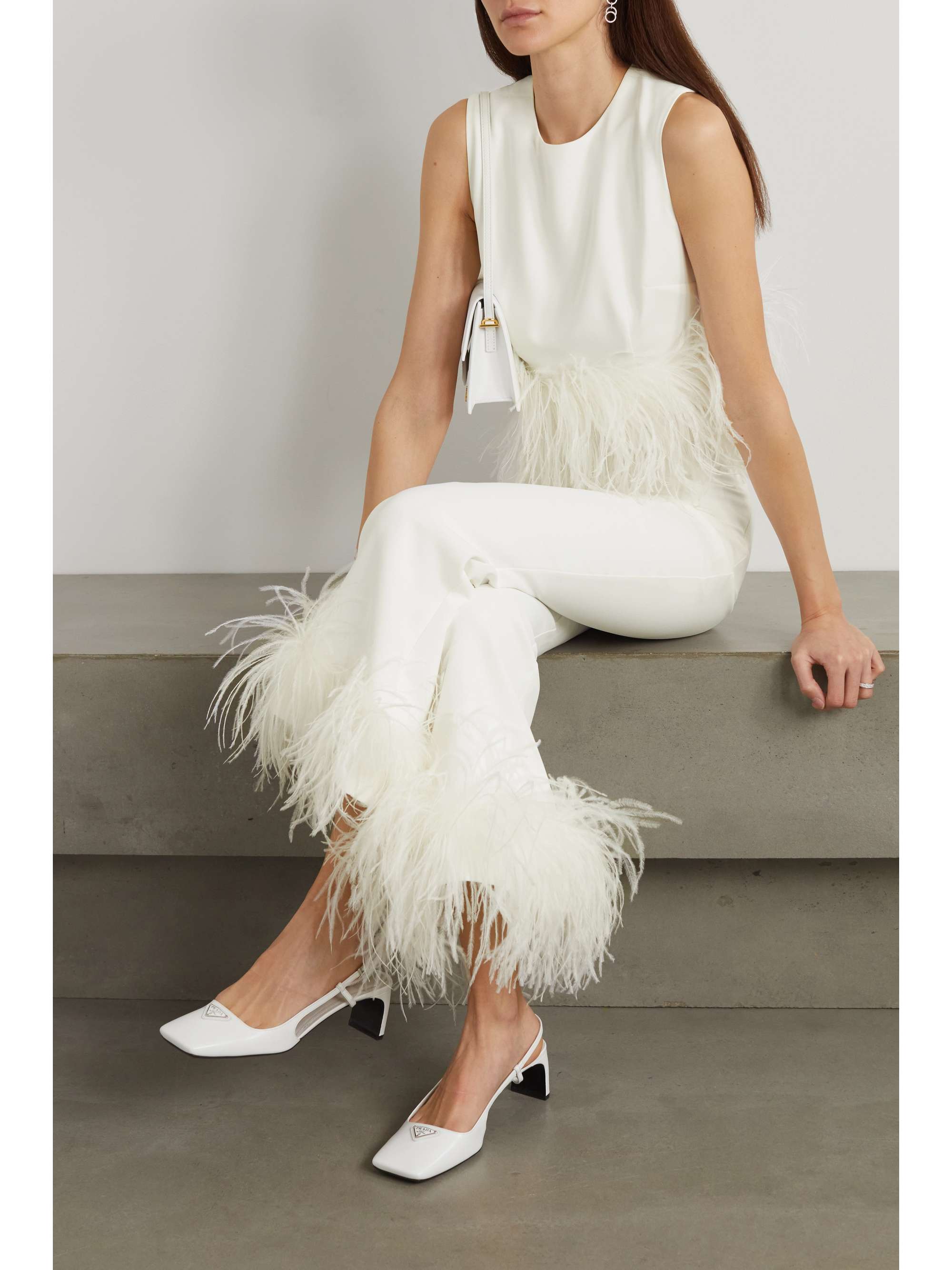 16ARLINGTON has quickly become a go-to for modern brides, thanks to its timeless silhouettes and playful, glamorous details. This 'Hoku' top is cut from smooth crepe and has wispy feathers tracing the cropped hem. Wear yours with the matching pants and pointed pumps.