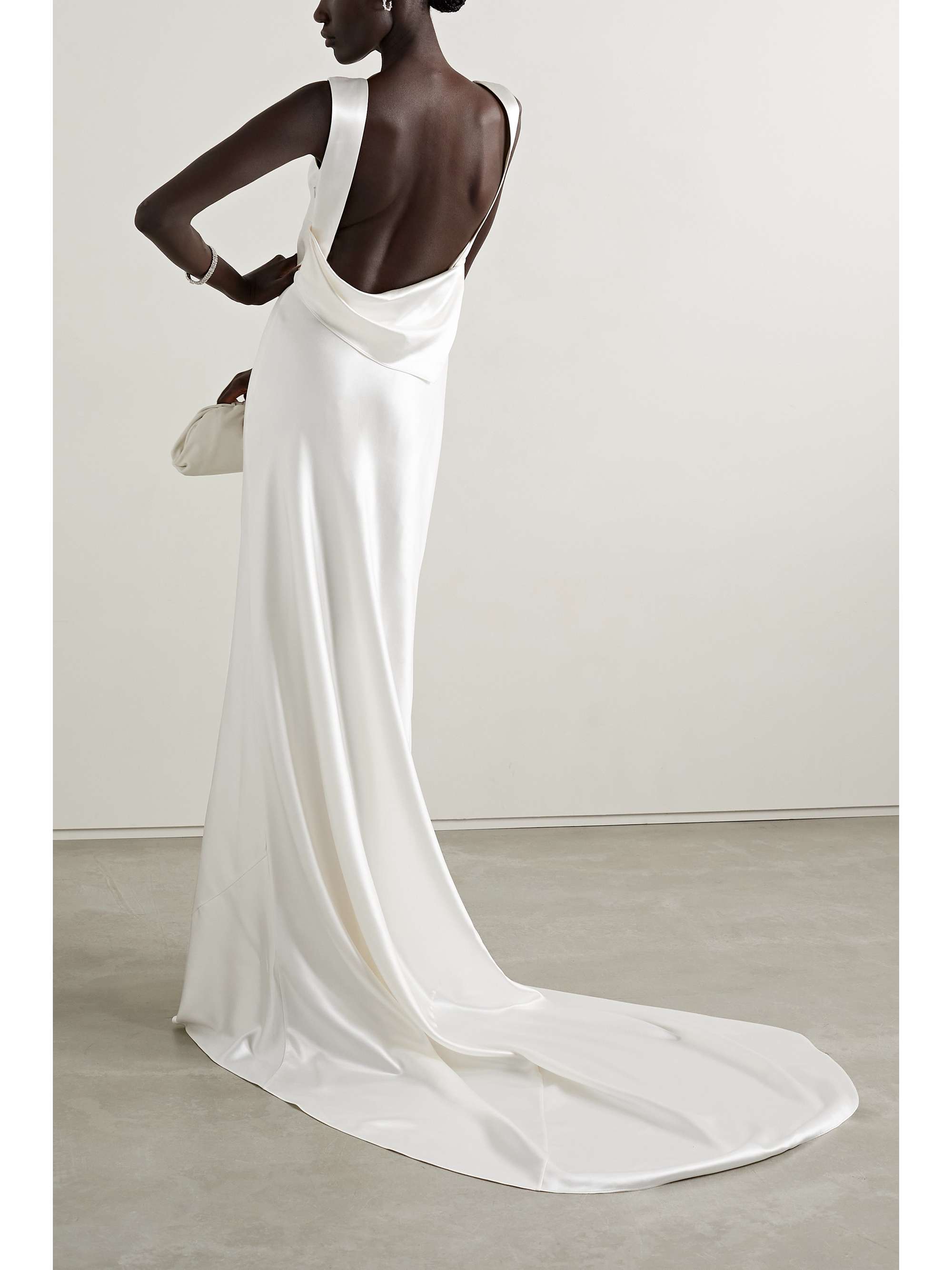 For the modern bride, Danielle Frankel's designs are elegant and timeless. This 'Charlie' gown is made from fluid wool and silk-blend charmeuse in a streamlined silhouette that drapes beautifully over your body with a high cowl neckline. Style your hair in an updo to put the draped open back on display.
