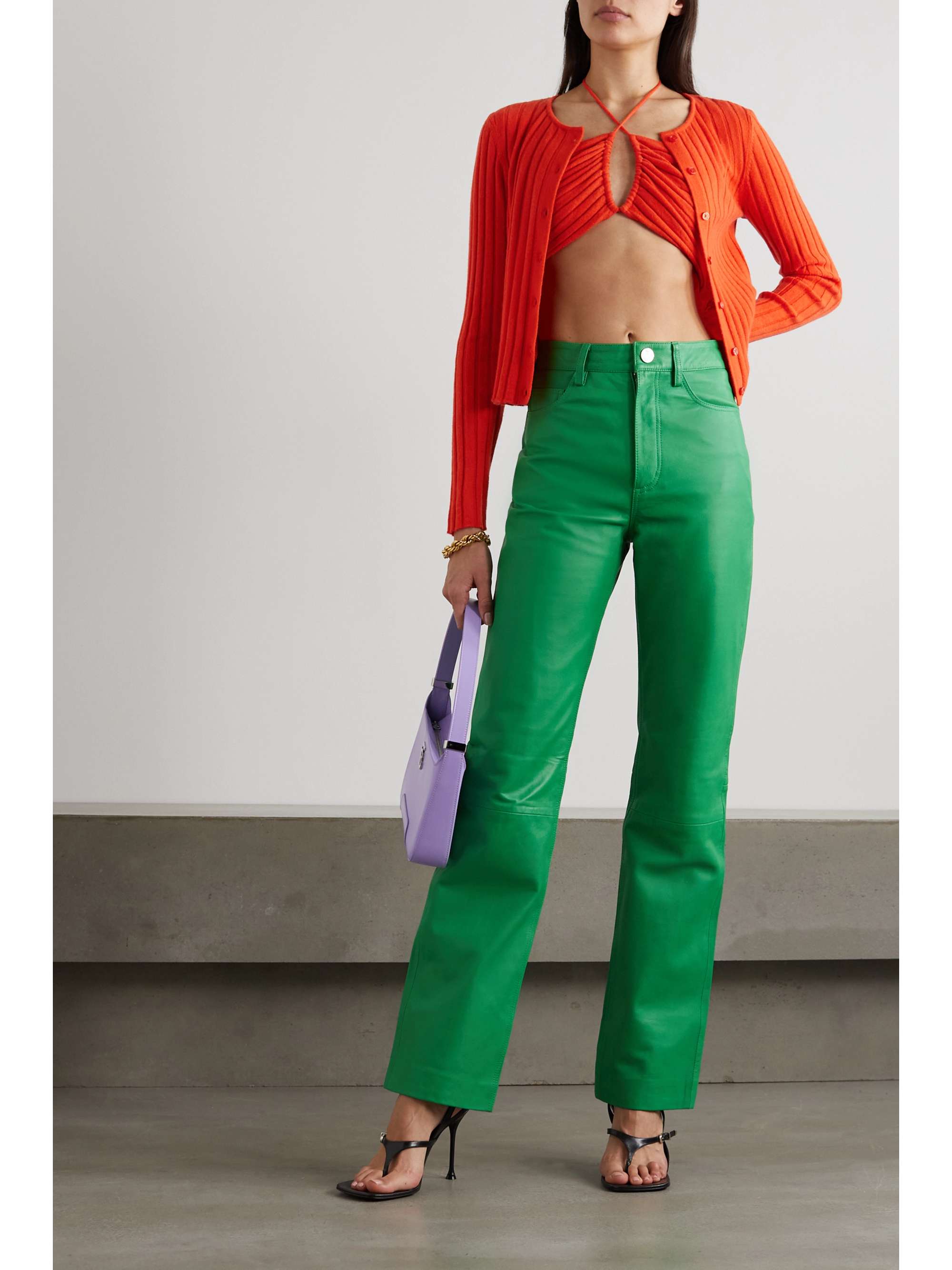 Red knit co-ord is made from softly ribbed cashmere that's partly recycled in an effort to reduce waste. The bralette has crossover straps that create an alluring keyhole detail at the front and the cropped cardigan fastens with buttons.