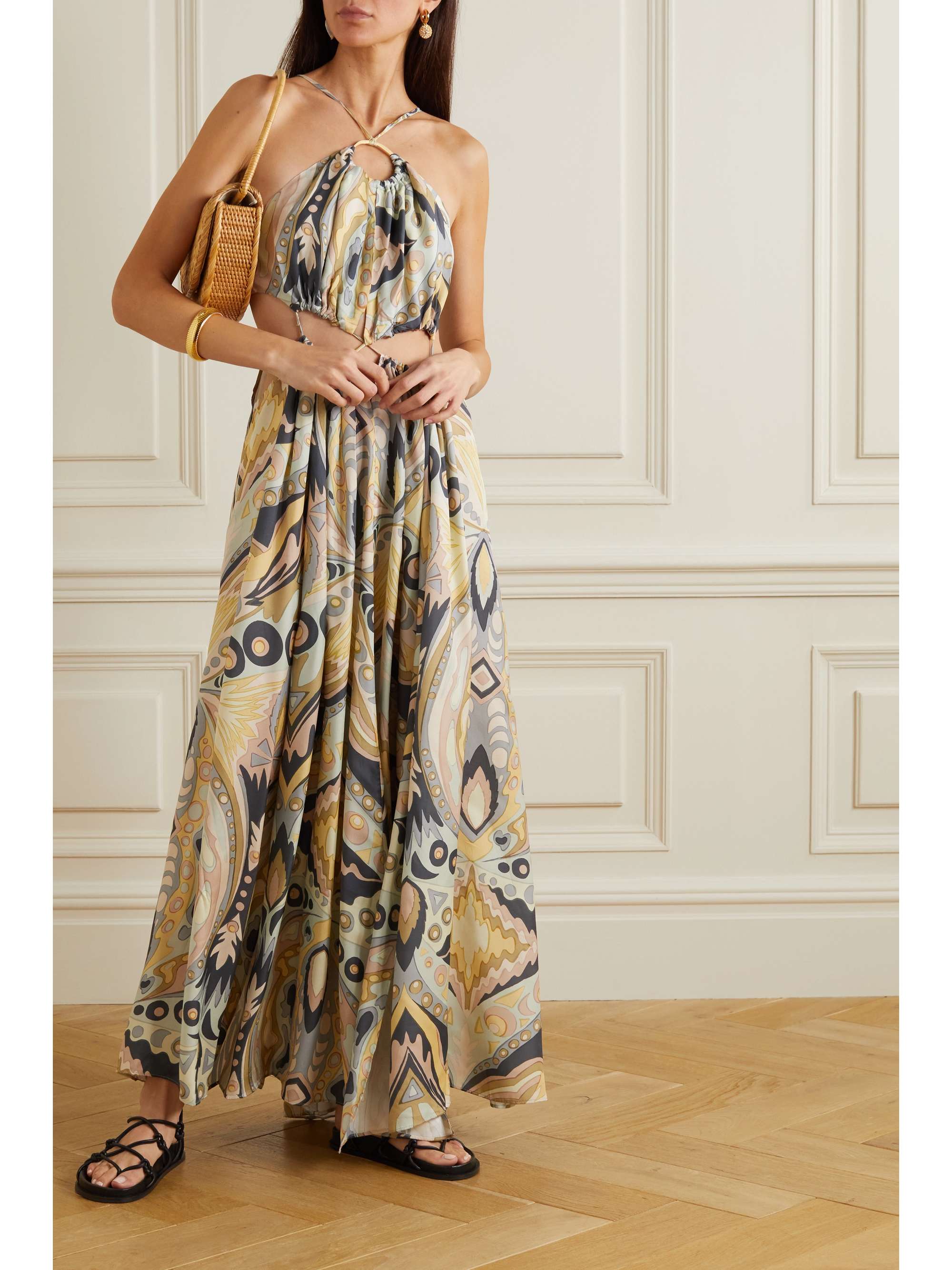 Named after the Greek goddess of love and beauty, Cult Gaia’s ‘Aphrodite’ gown is designed with slim straps connecting the floaty skirt to the cropped top. It's made from crepe blended with silk for a fluid drape and has an intricate retro swirly print. Cutouts along the midriff and keyhole fastening to thin-strapped halterneck ties at the neck. 