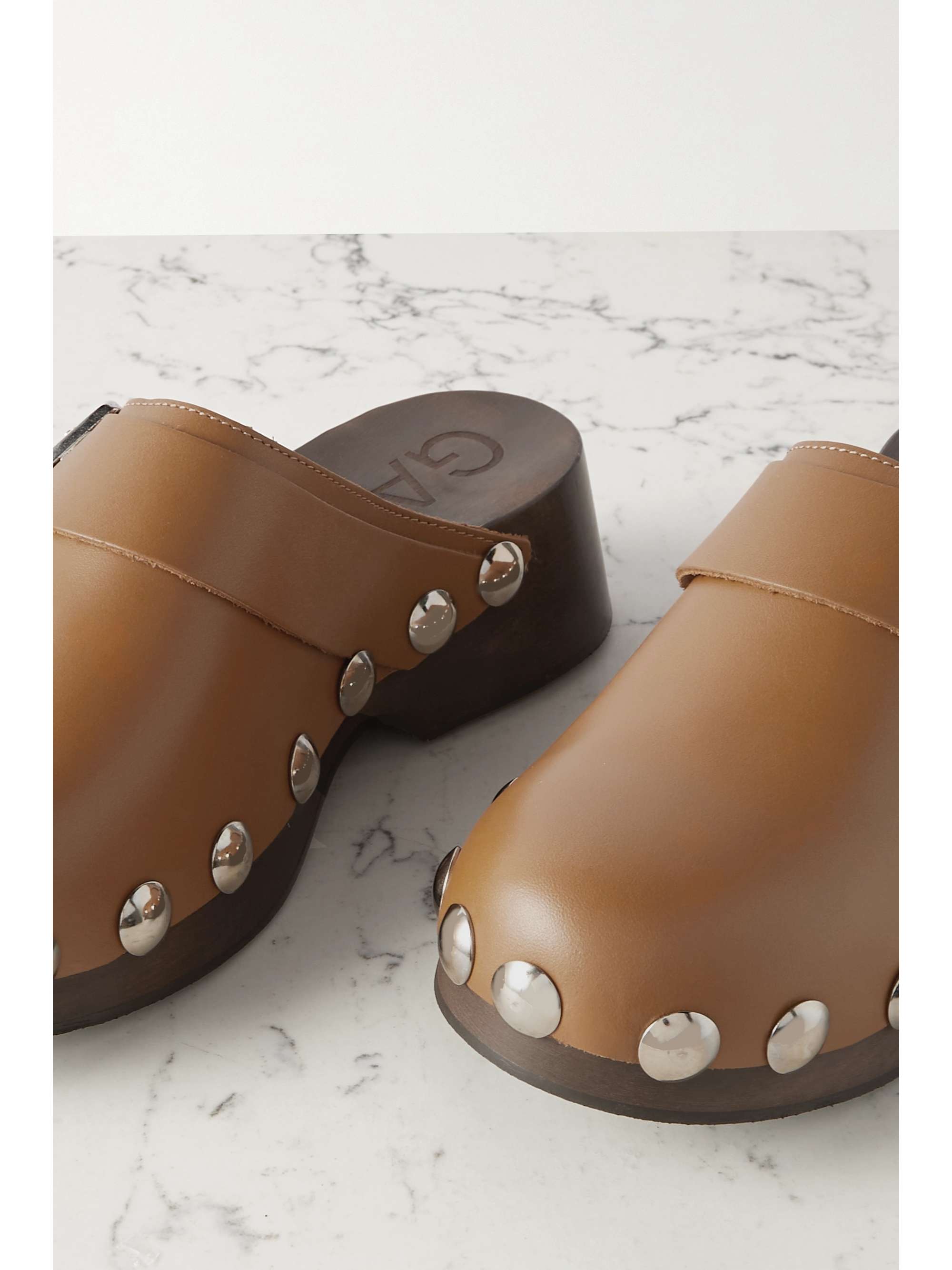 GANNI Studded buckled leather clogs