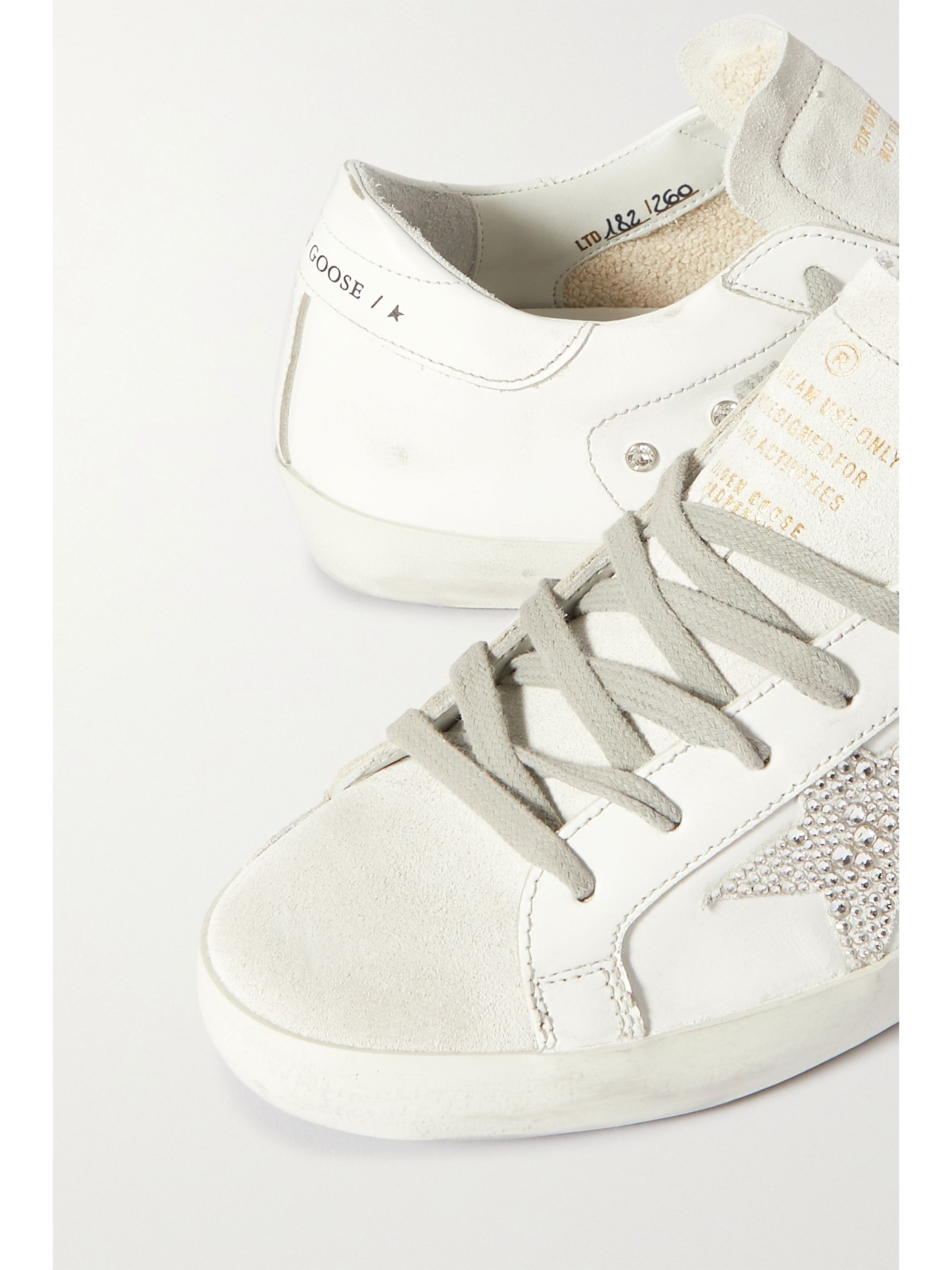 White Superstar crystal-embellished distressed leather and suede ...