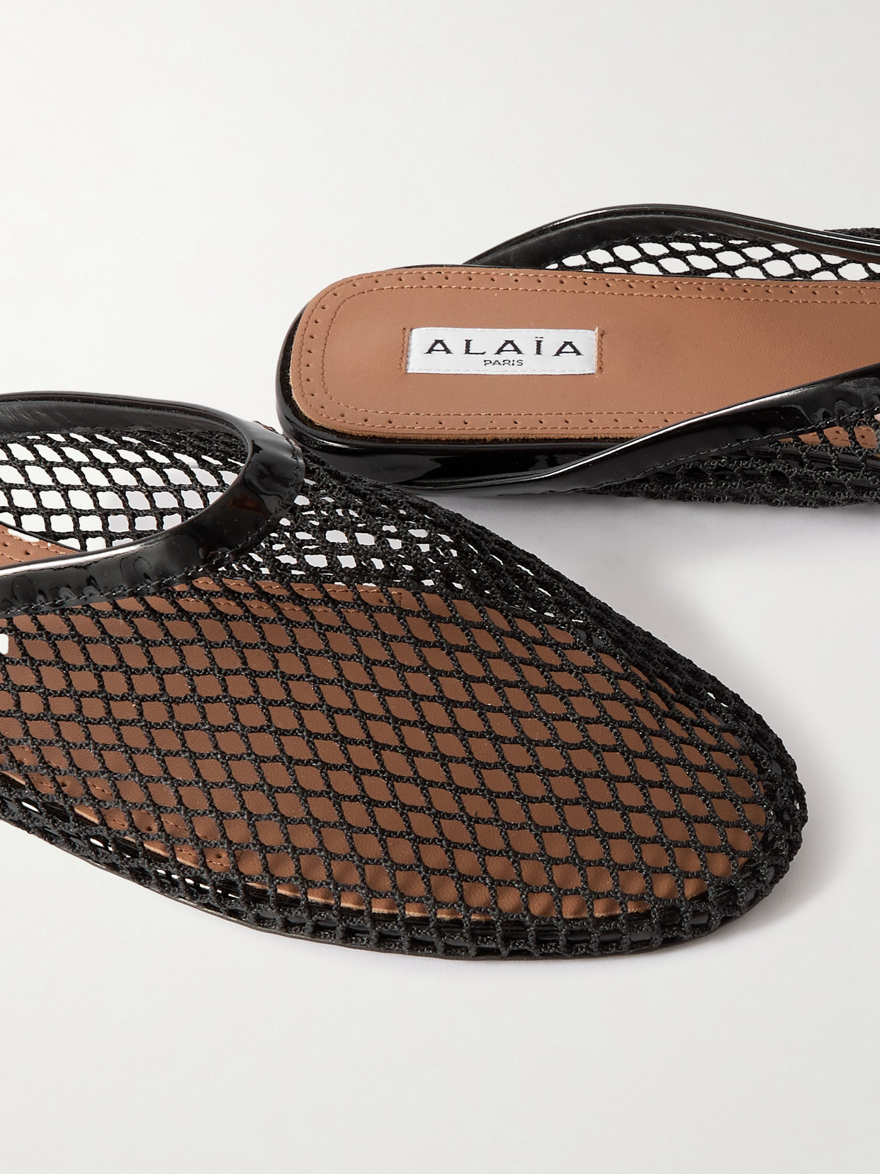 ALAÏA LEATHER-TRIMMED FISHNET MULES