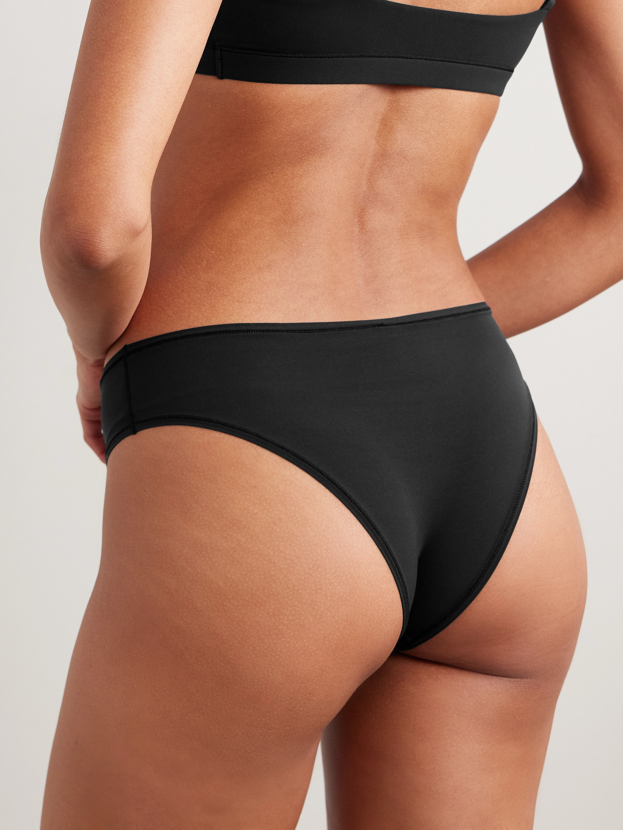Skims Smoothing Mid-rise Stretch-woven Thong In Black