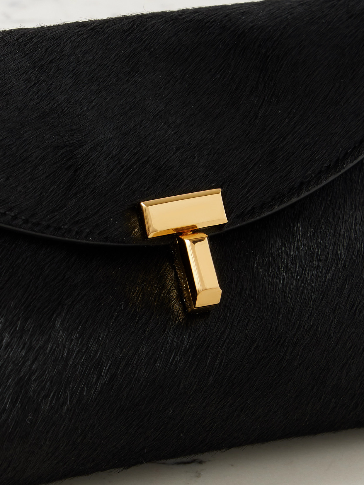 Totême T-lock Mini Calf Hair Clutch In Black