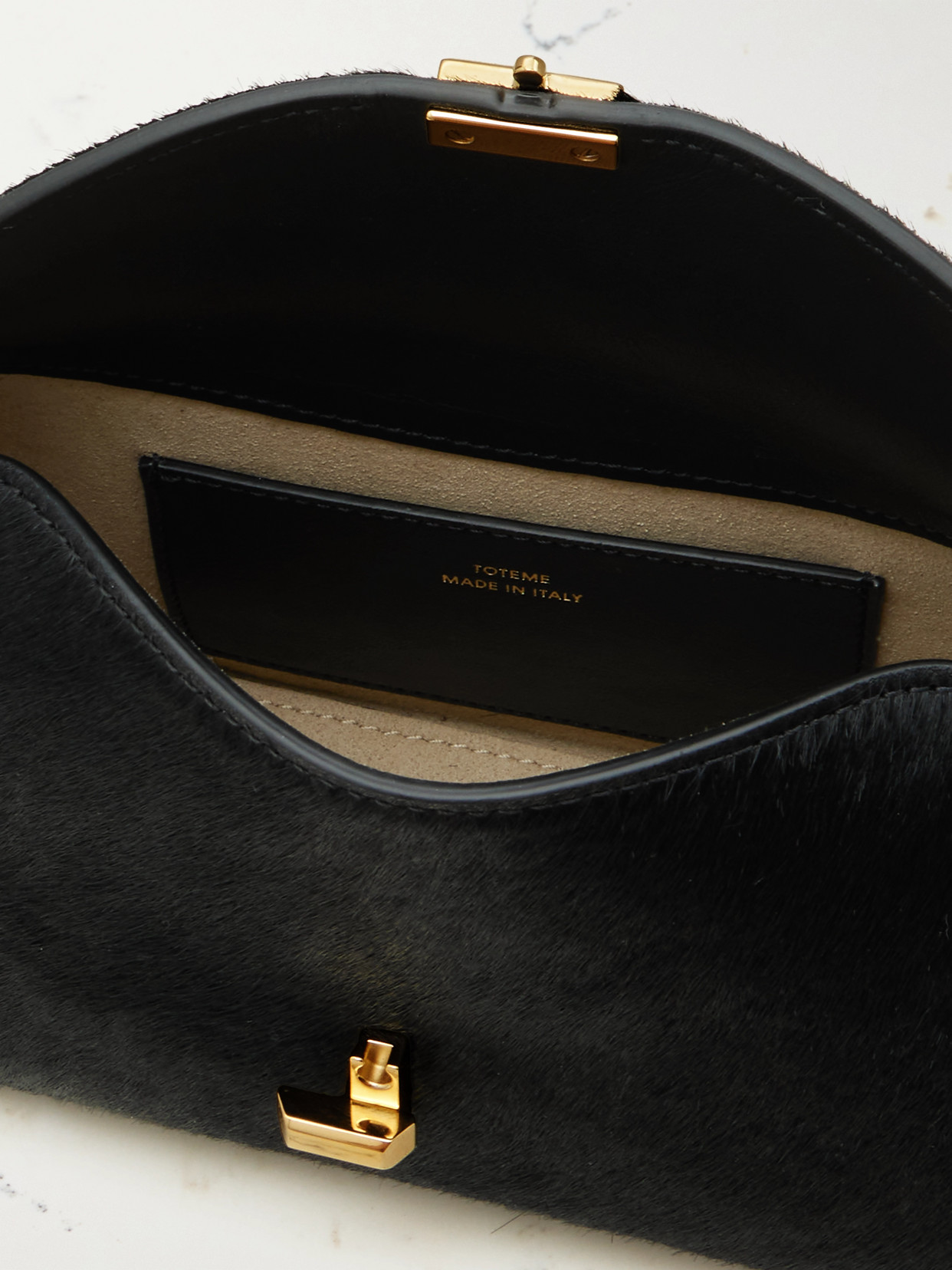 Totême T-lock Mini Calf Hair Clutch In Black