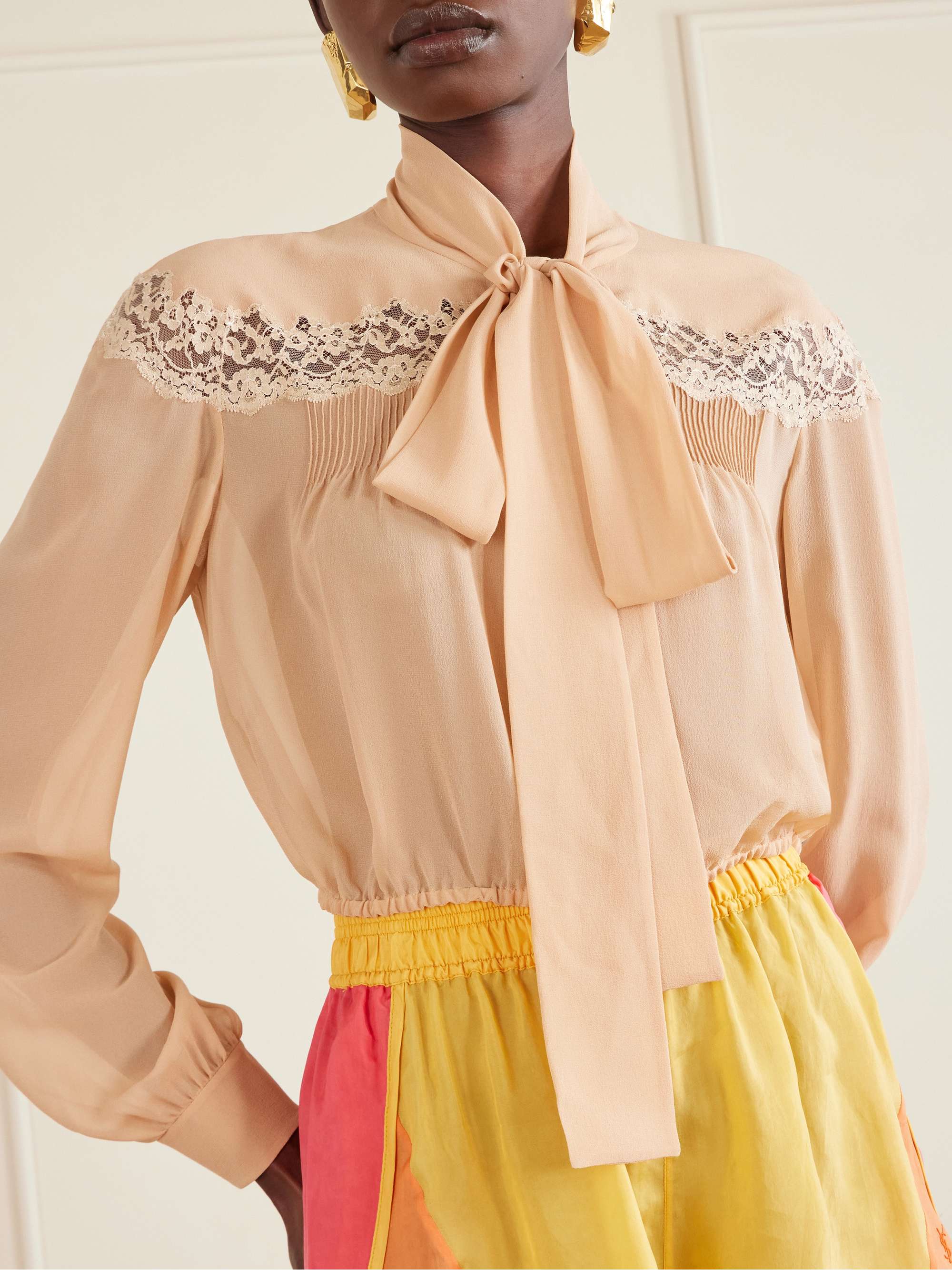 SAINT LAURENT Cropped pussy-bow lace-trimmed silk-georgette blouse