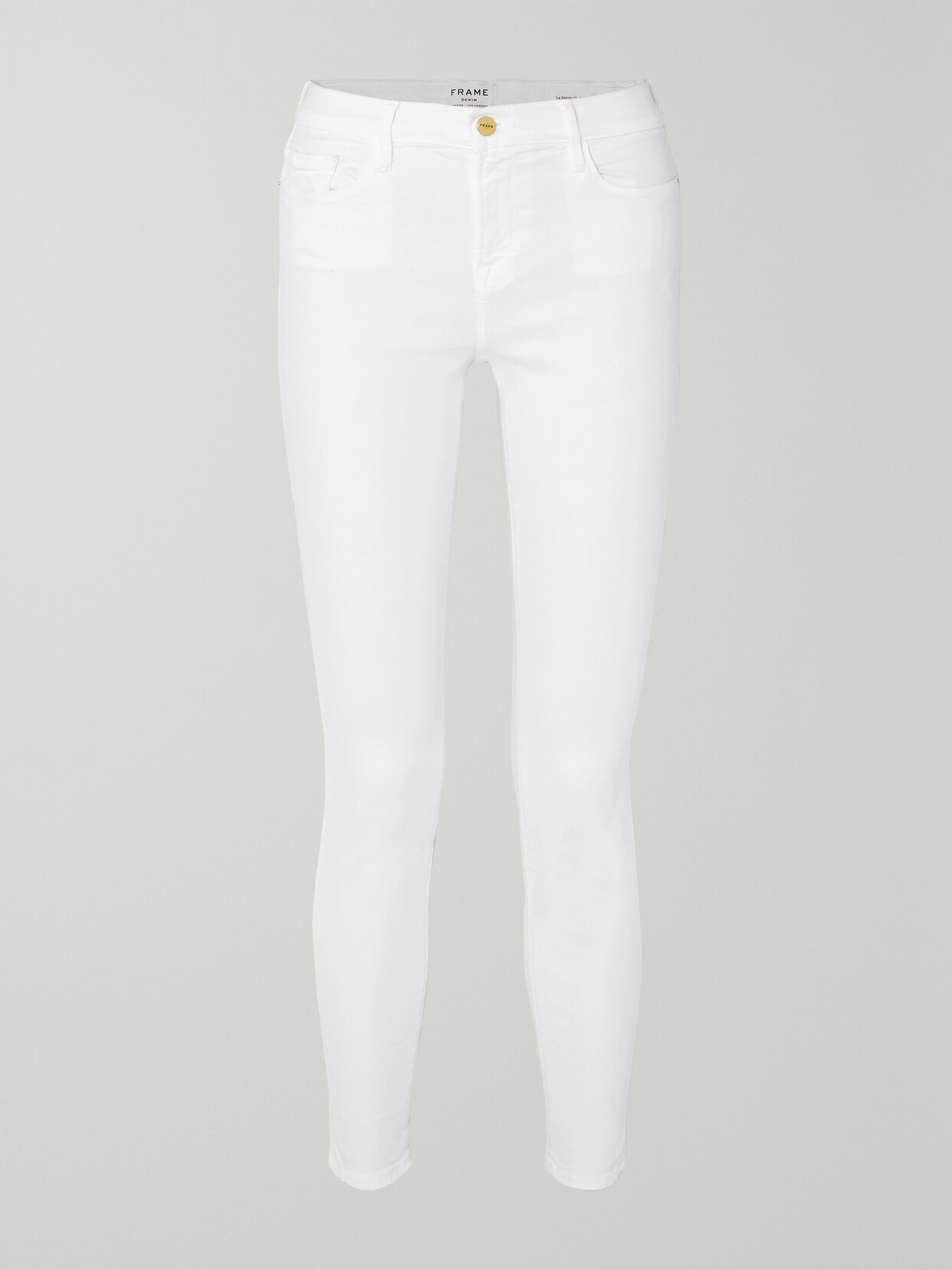 Shop Frame Le Color Mid-rise Skinny Jeans In White